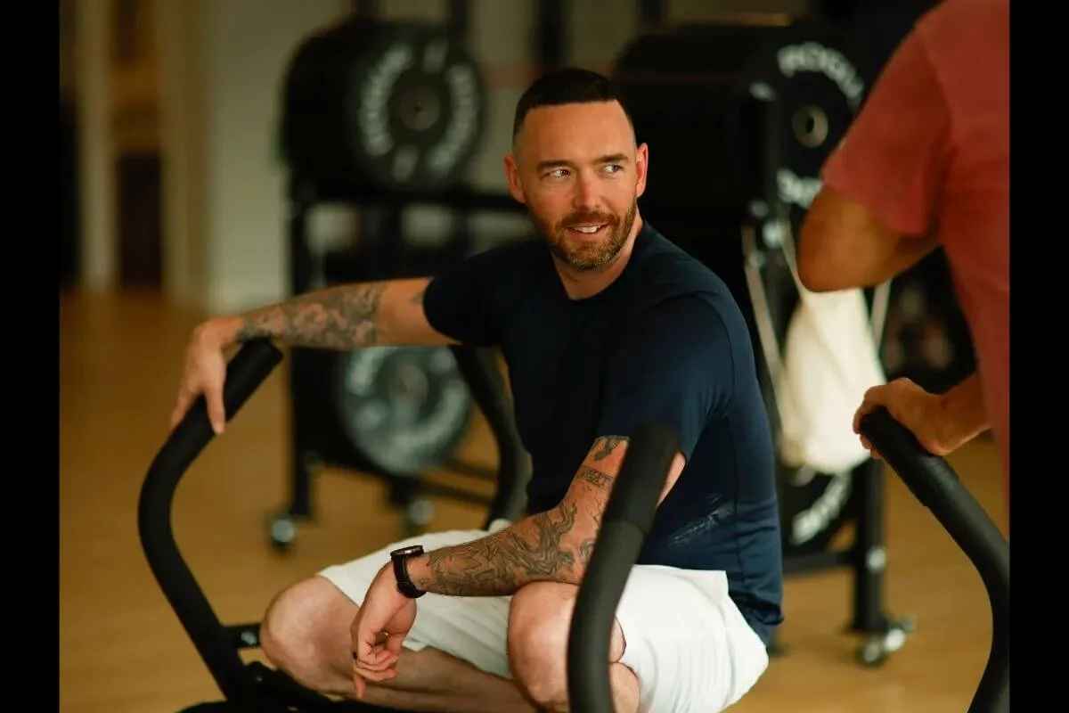 Owner of The Genesis Fit - Christopher Ryan, sitting on a sled at The Genesis Fit in Marshfield MA