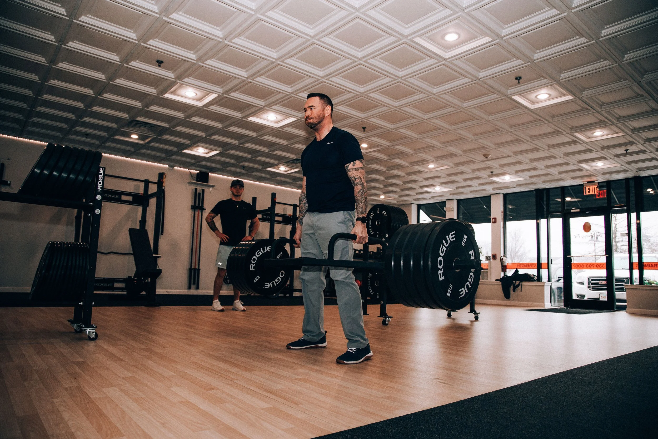 Owner of The Genesis Fit- Christopher Ryan doing a trapbar deadlift of 470lbs after recovery from back injury