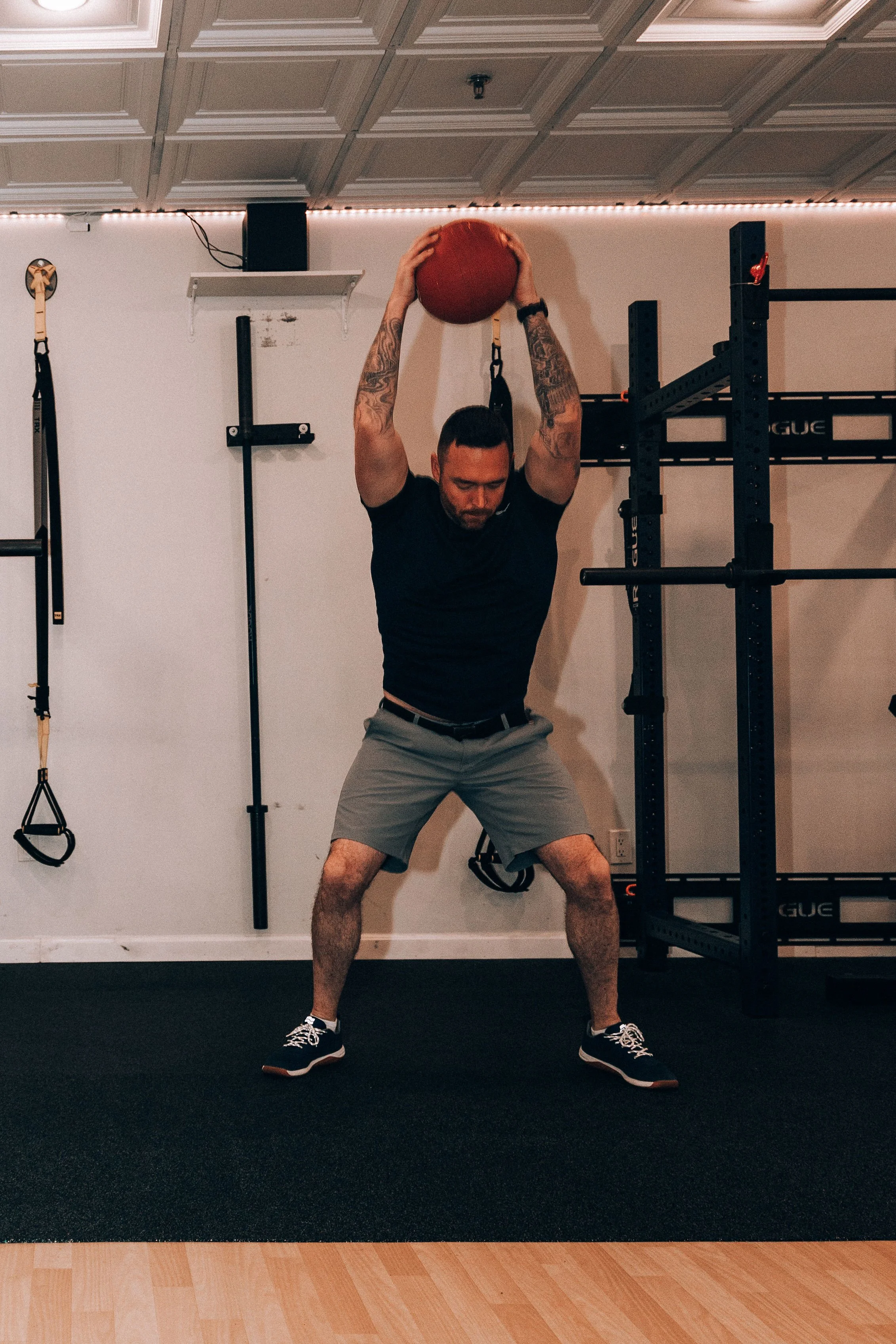Owner Christopher Ryan Strength training after 40. He is doing Ball Slams demonstrating power, and mobility.