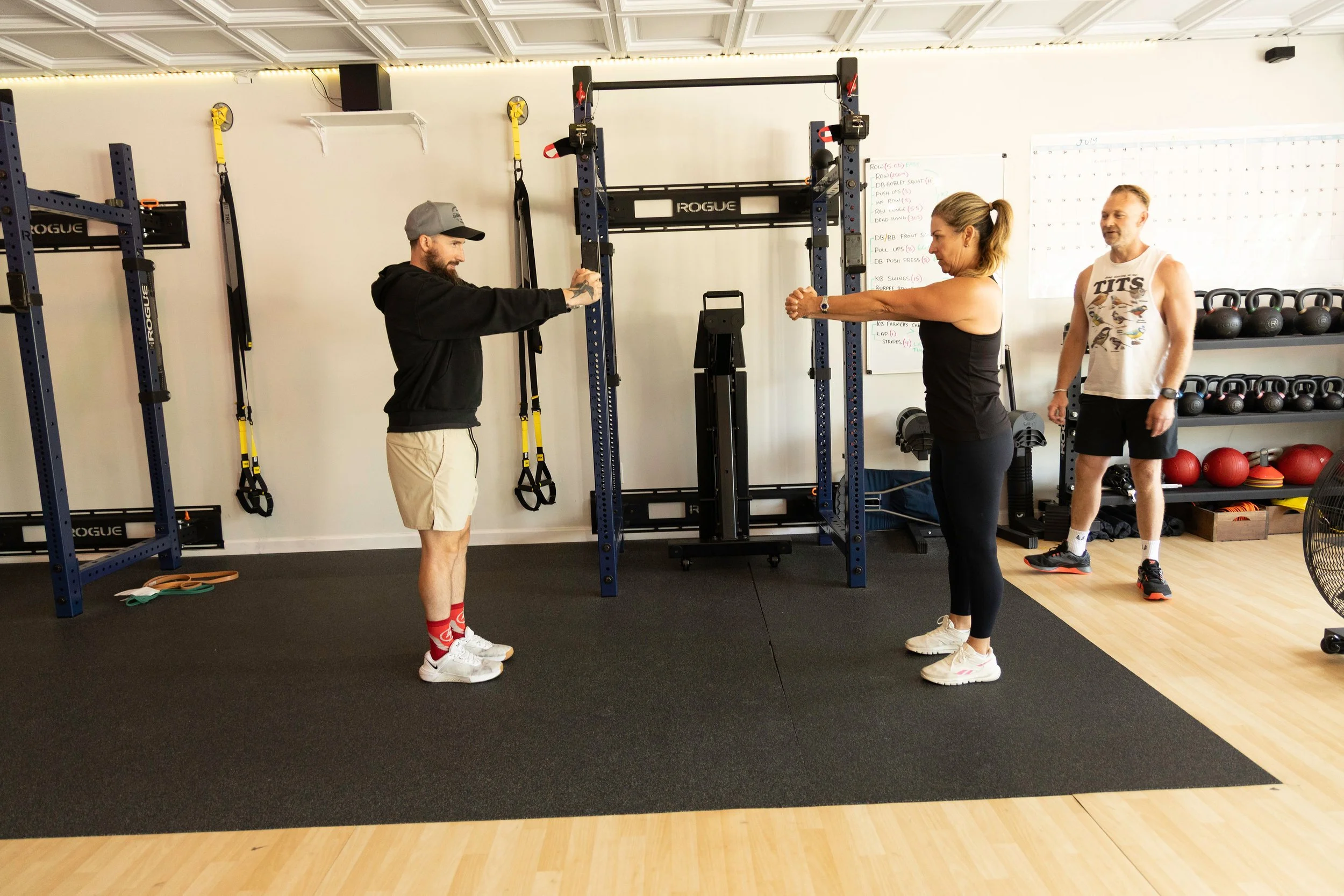 Genesis Fit Trainer working alongside client doing physical therapy movements before surgery