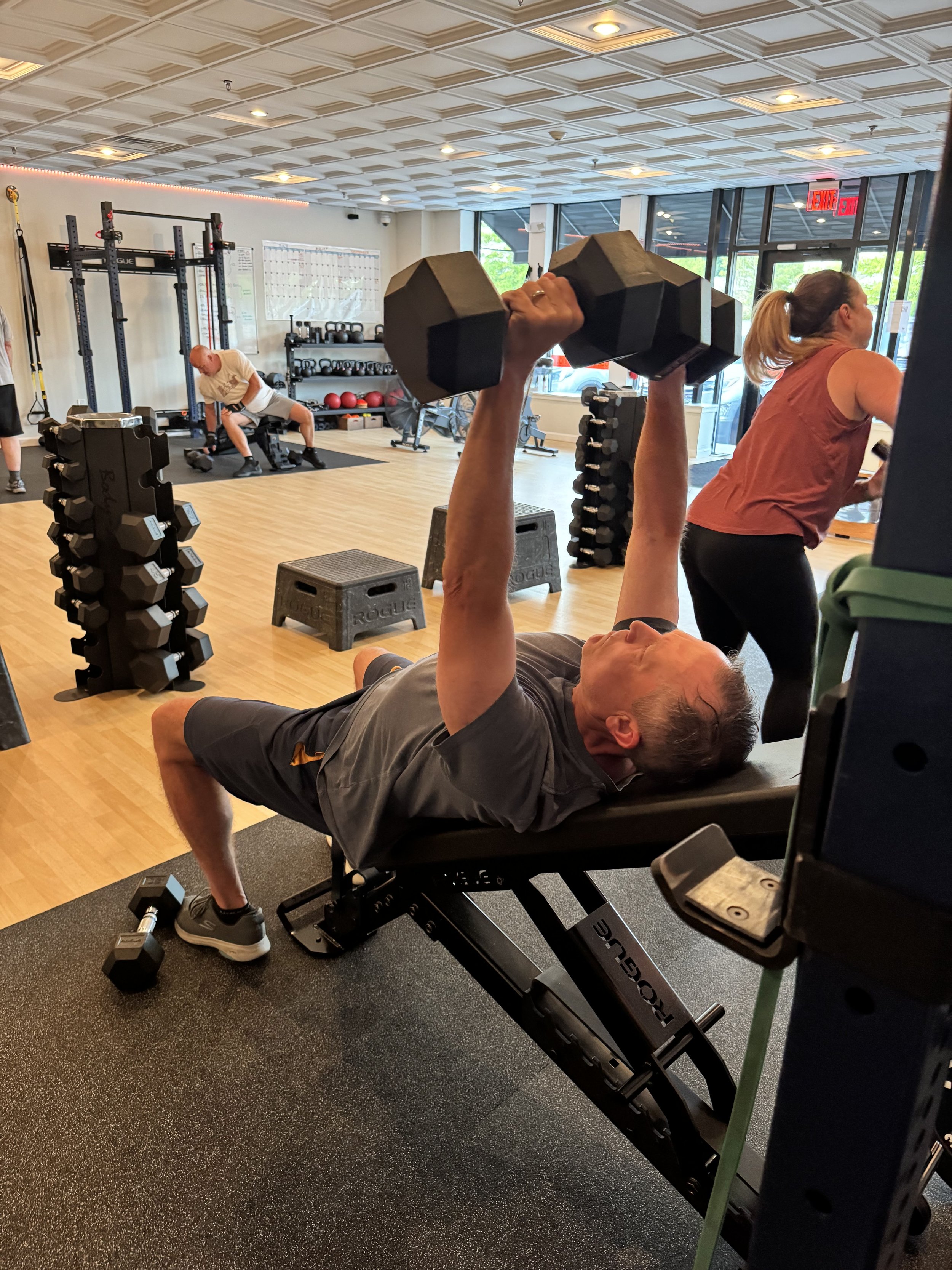 Semi-private class at the genesis fit with multiple clients over 50 doing strength training