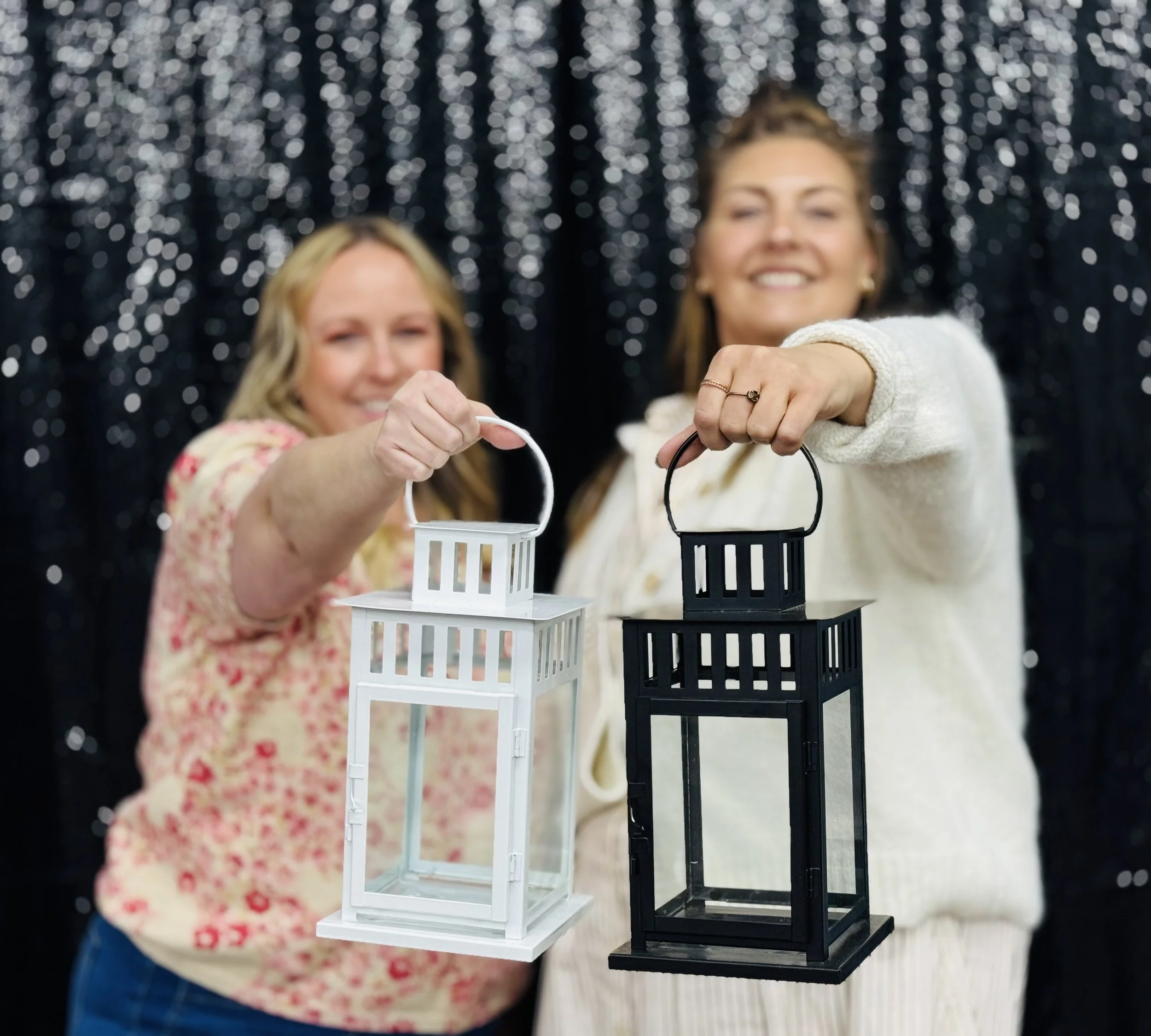 Shannon and Erin holding decorative lanterns for event rentals, decor rentals, at The Haven Collective in Green Bay, Wisconsin