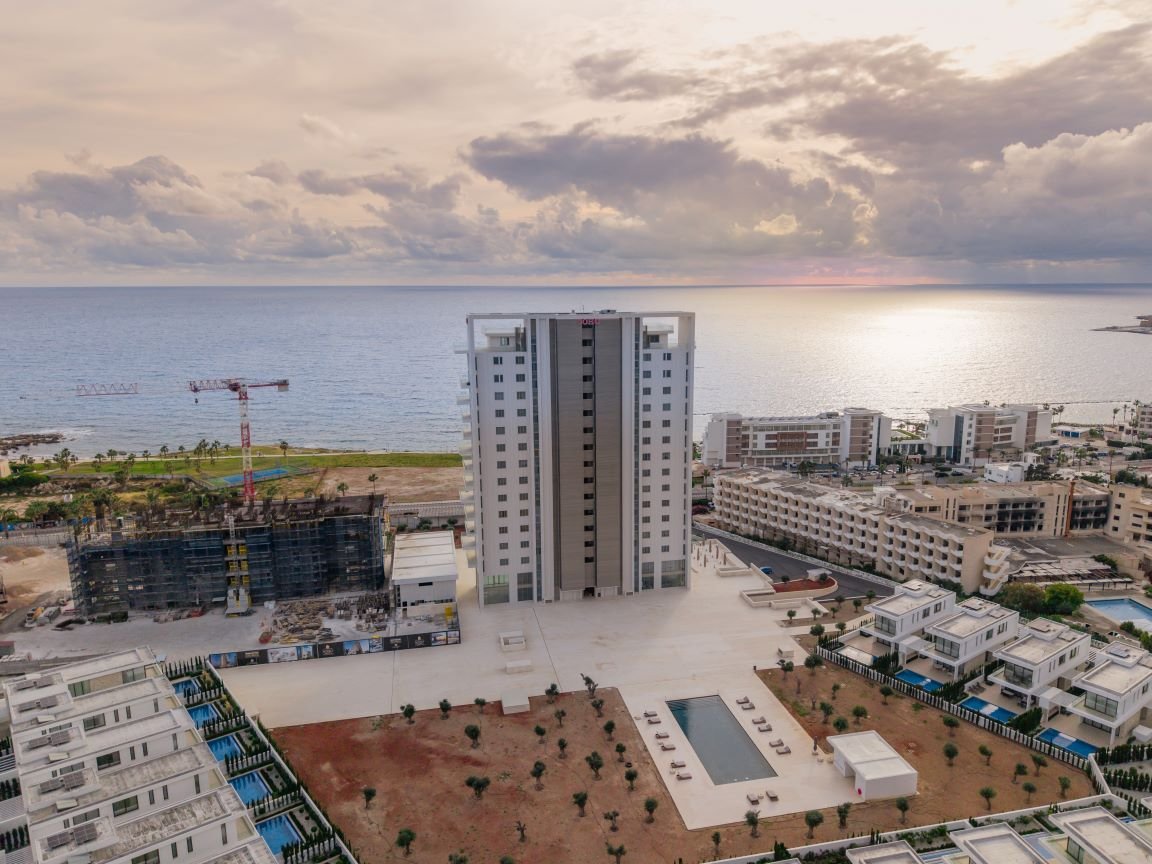 Cinematic drone aerial view of Soho Resort tower in Kato Paphos by Amarantos Films.