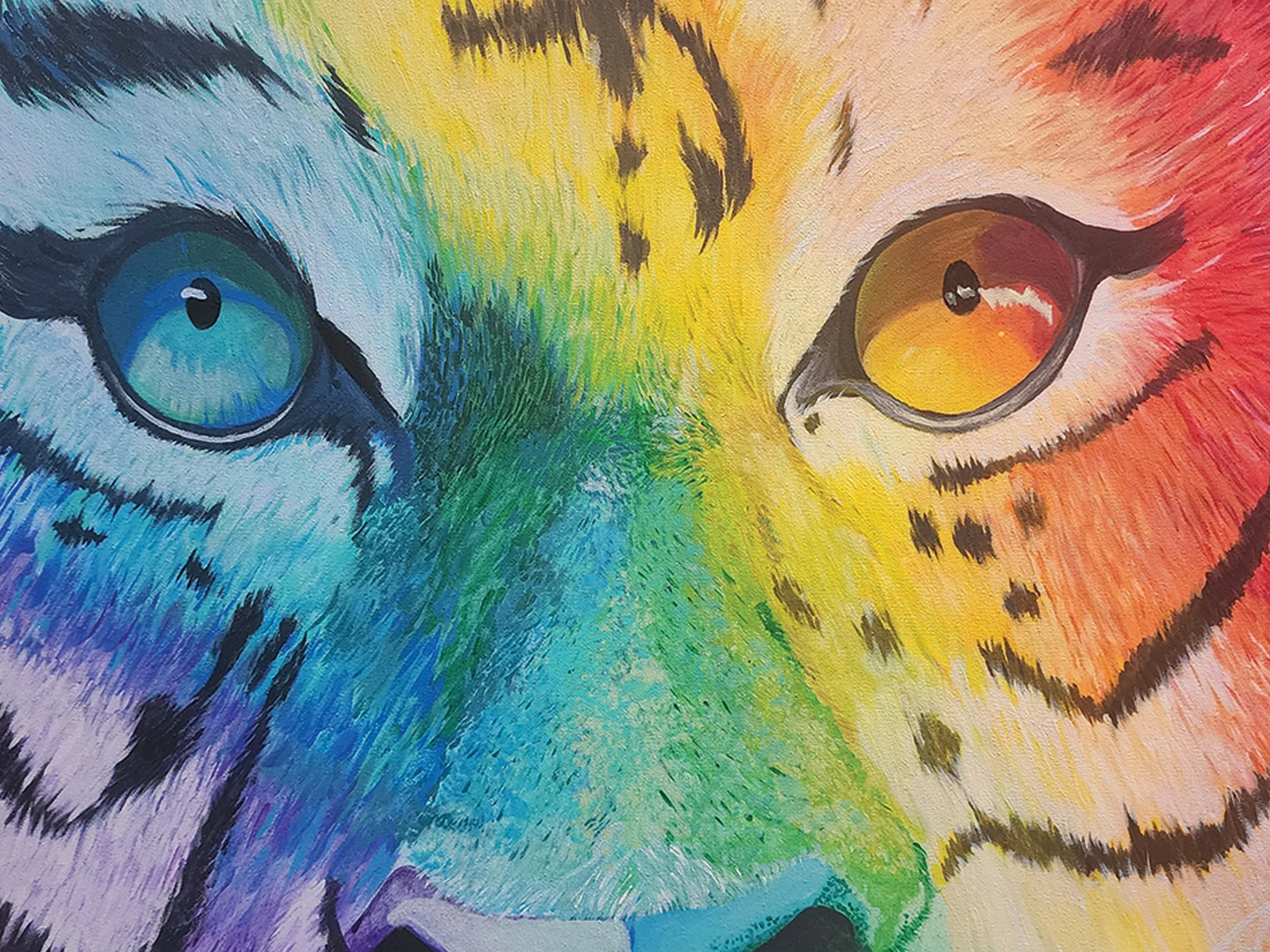 Colorful painting of a tiger face with rainbow colors