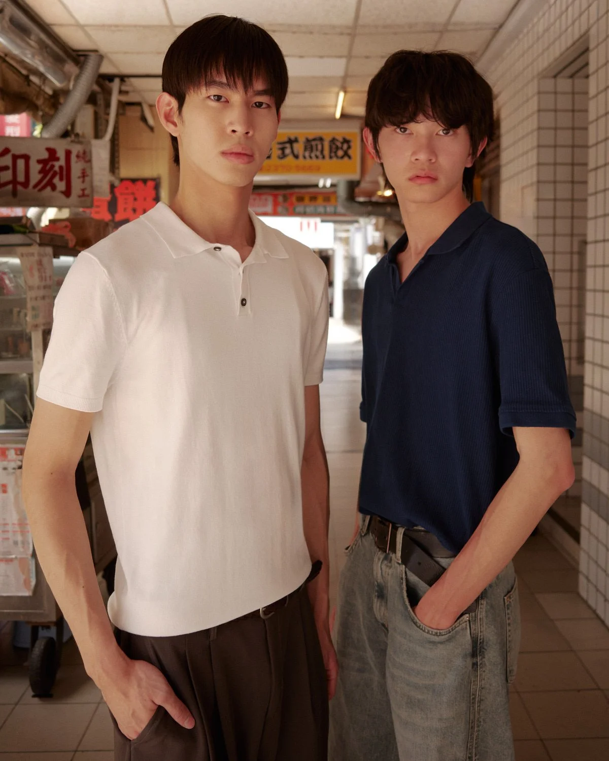 Two male models photographed together in a Taipei market street by Pedro Márnez