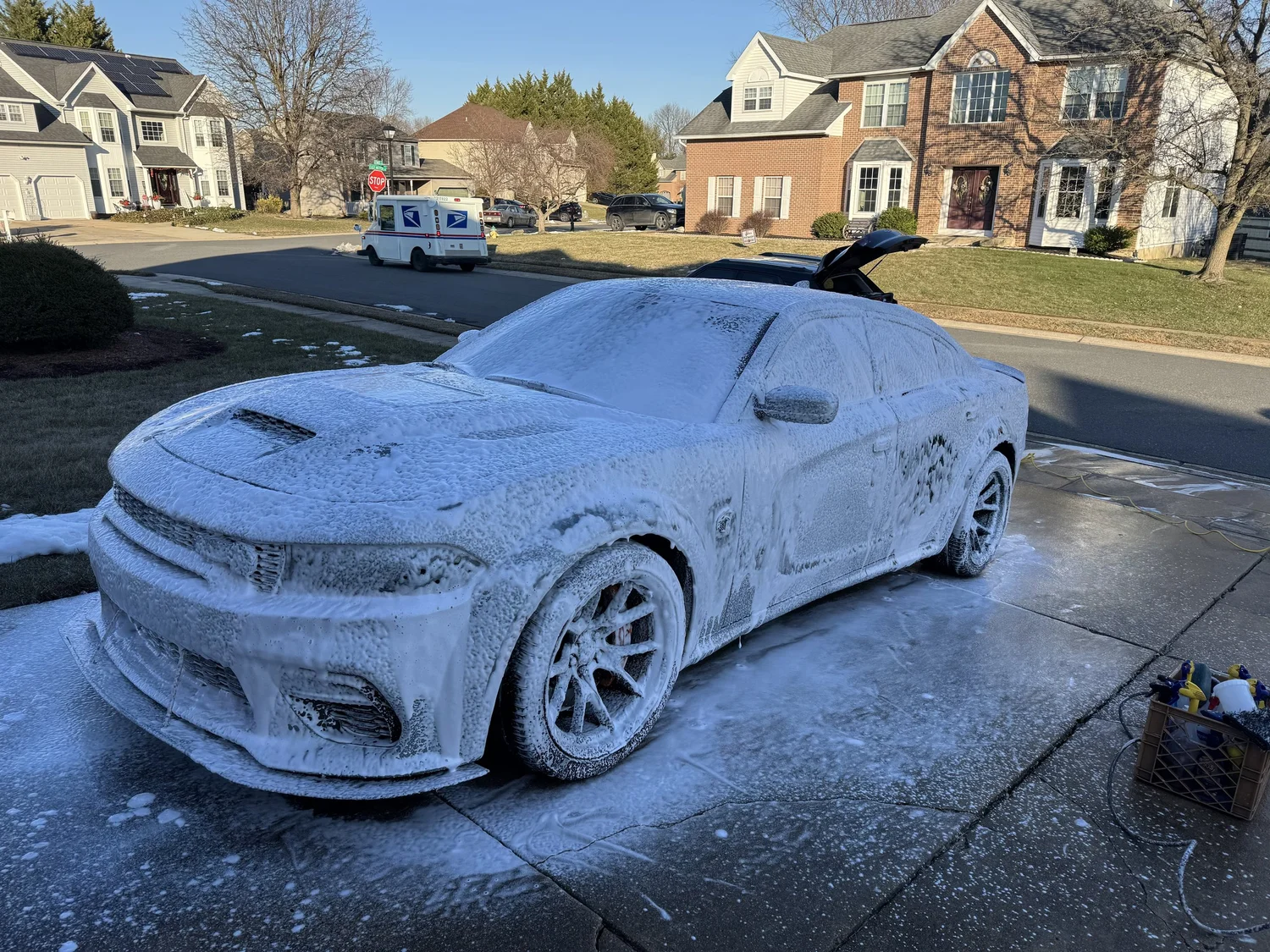 Vehicle covered in soap foam during an on-site wash