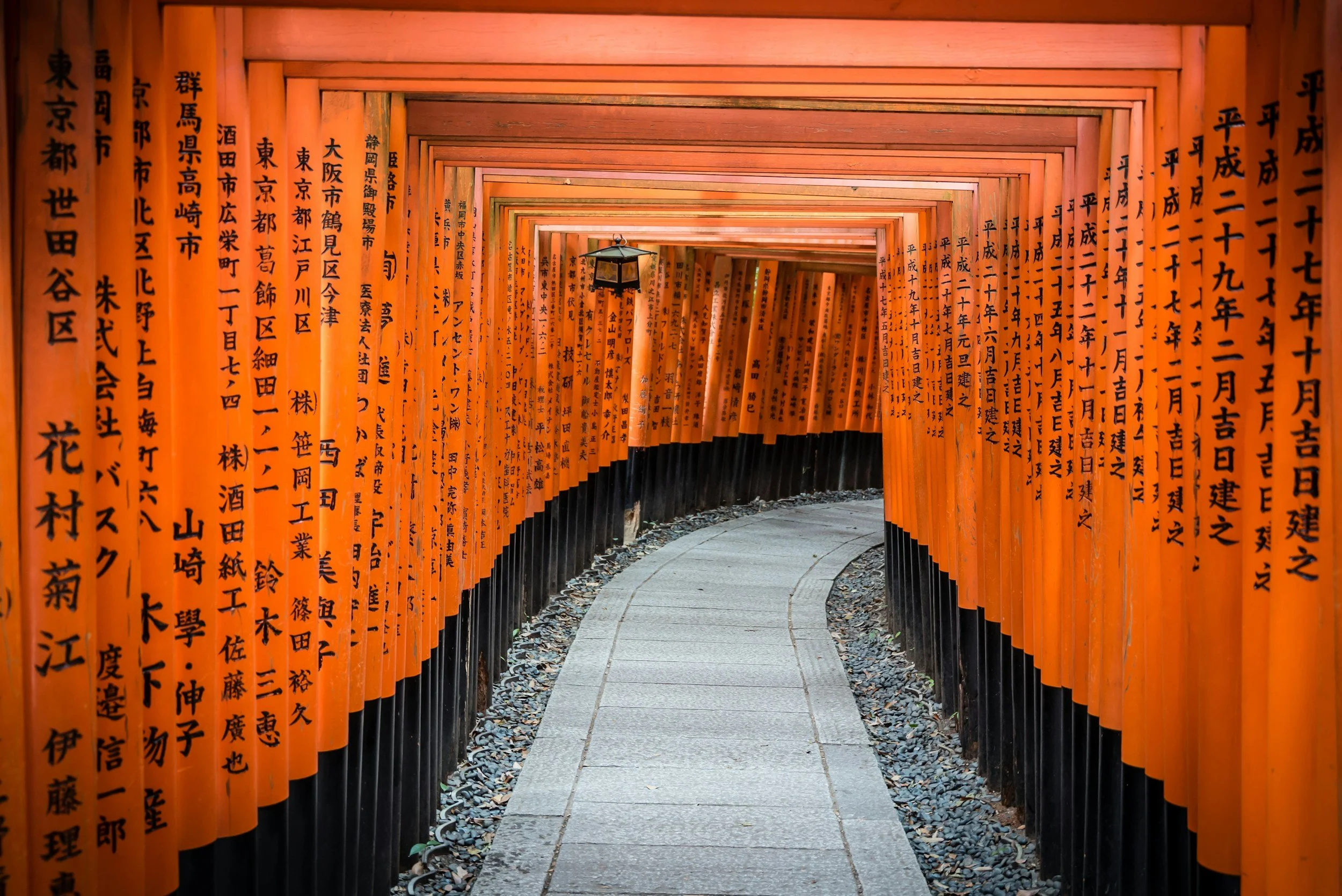 Vermilion torii gates on the path at Fushimi Inari, Kyoto.