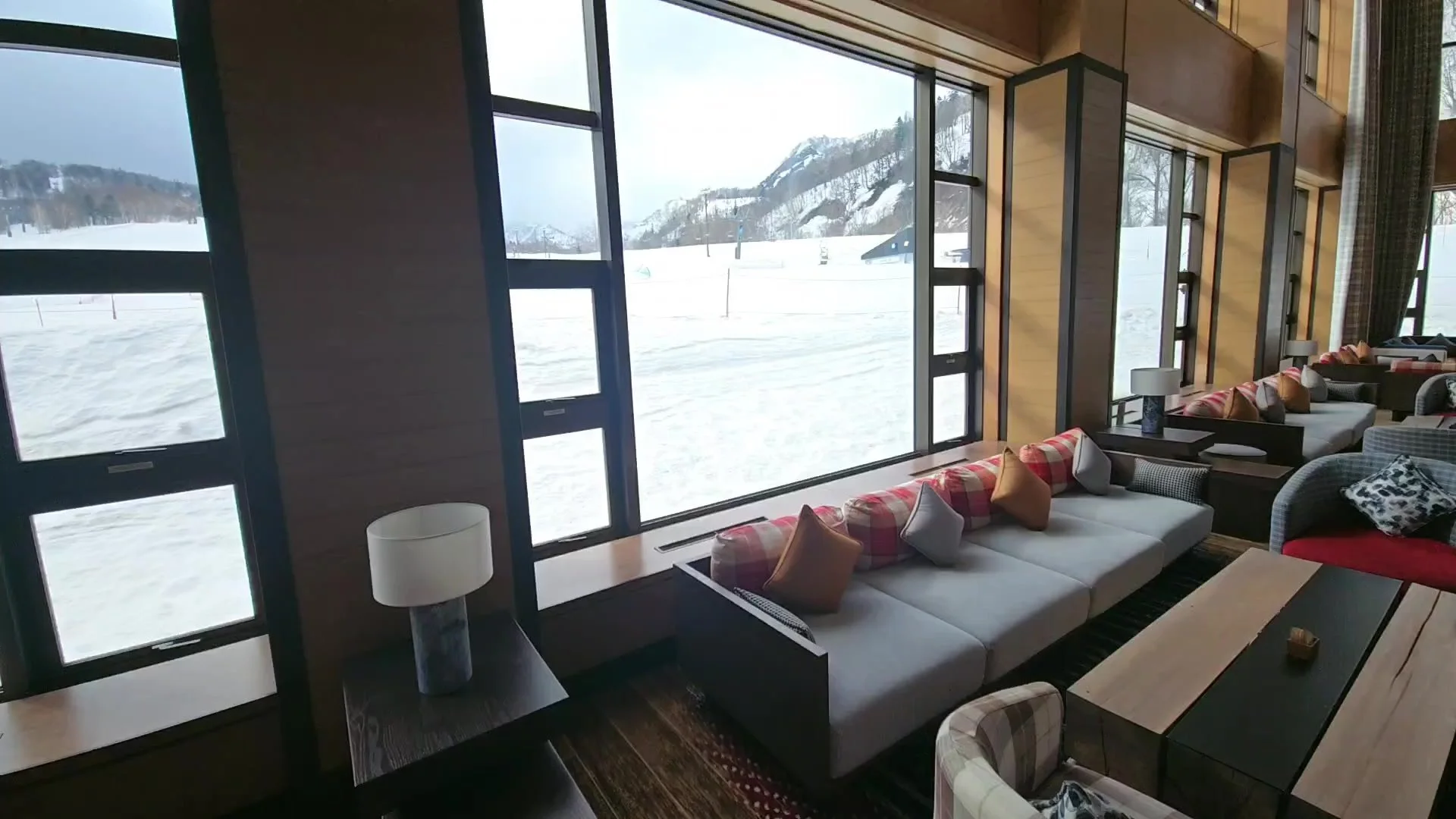 Bar lounge at Club Med Kiroro Peak with floor-to-ceiling windows over the ski slopes
