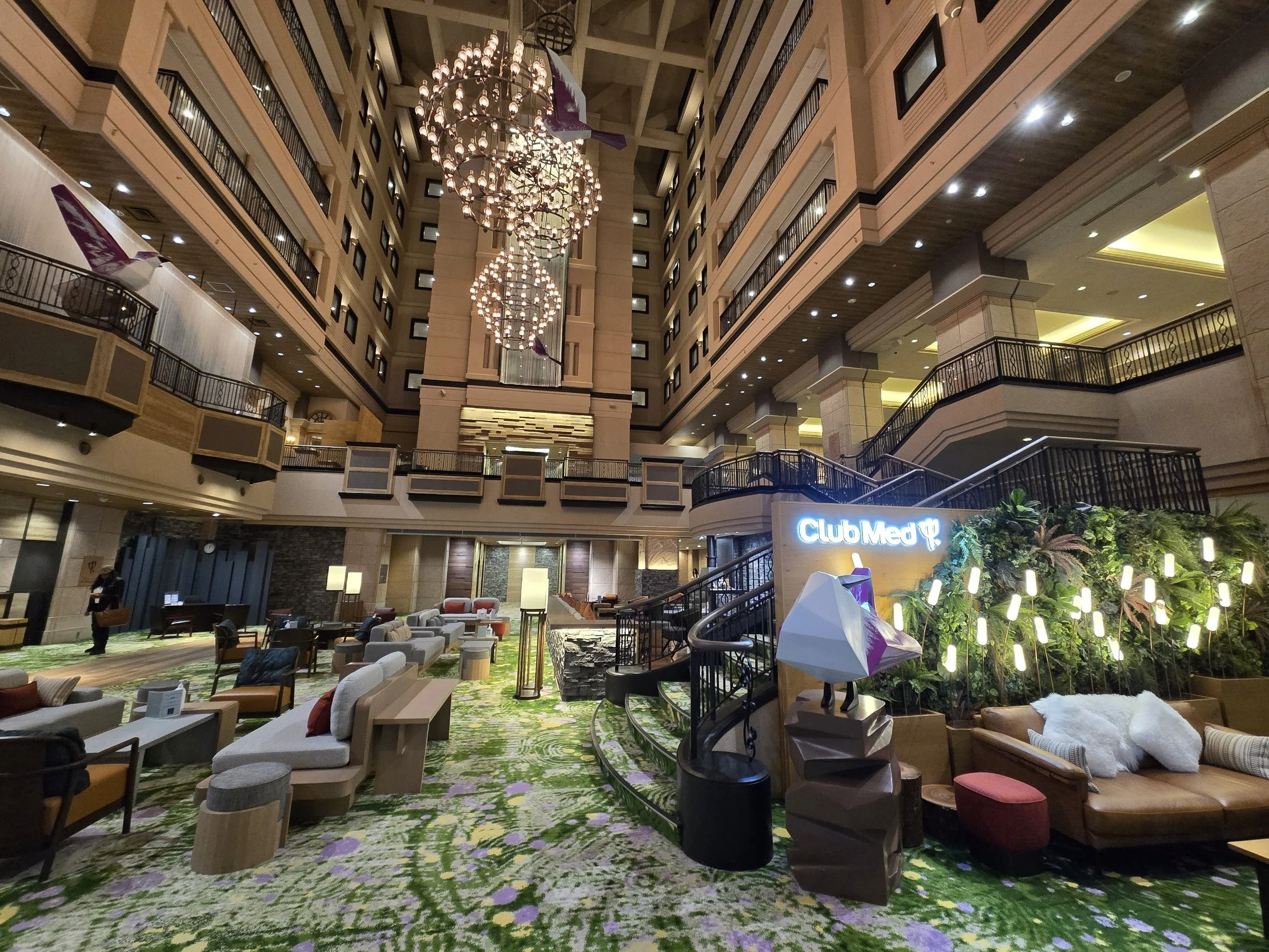 Atrium lobby of Club Med Kiroro Grand ski resort with chandeliers and lounge seating