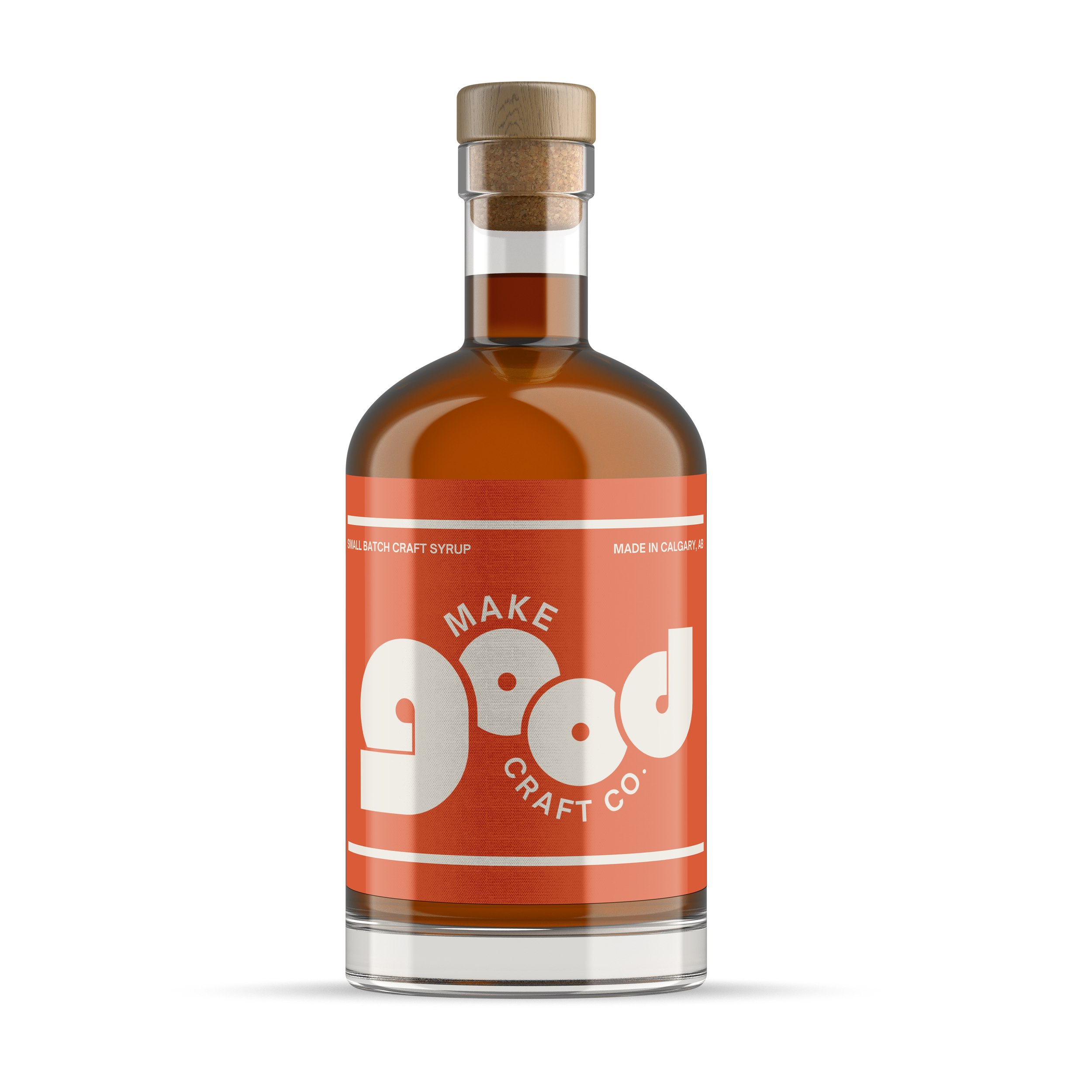 Bottle of craft syrup with an orange label and white text reading 'Make Good Craft Co.' and a wooden cap.