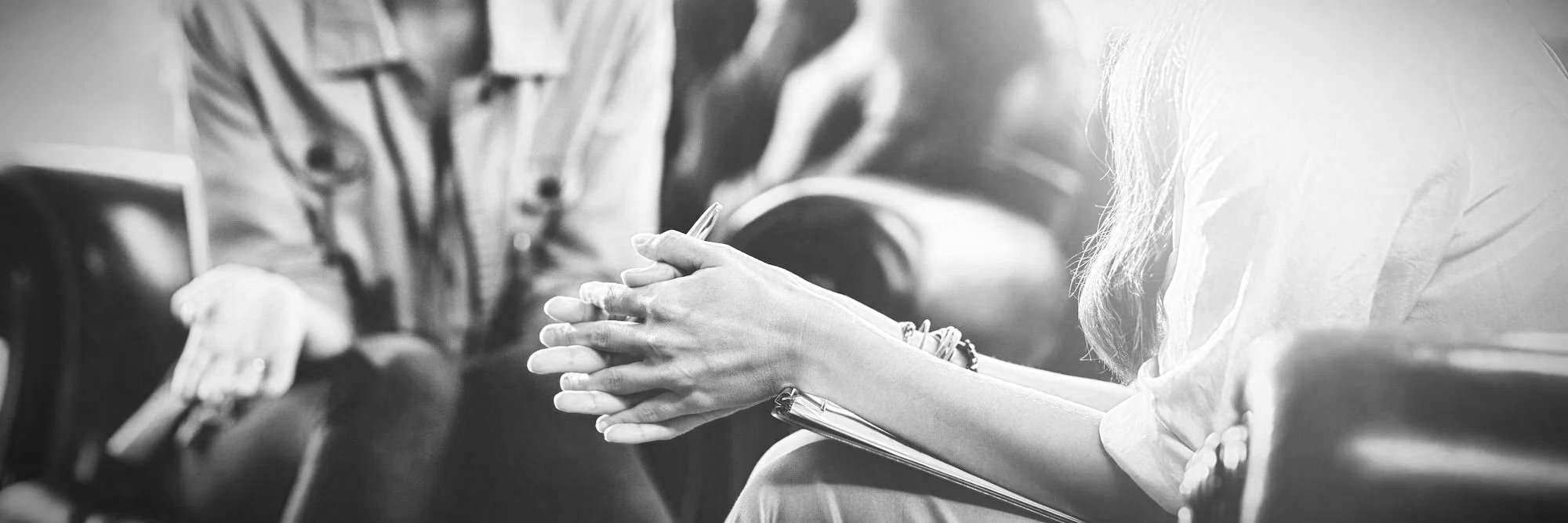 Person with light-colored shirt clapping hands in a waiting room.