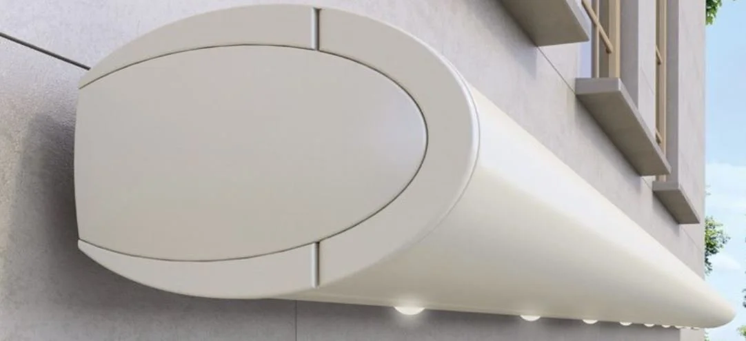 Close-up view of a white, futuristic, rounded outdoor air conditioning unit mounted on the exterior wall of a building.