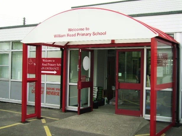 Entrance to William Read Primary School with a red and white canopy over the doorway