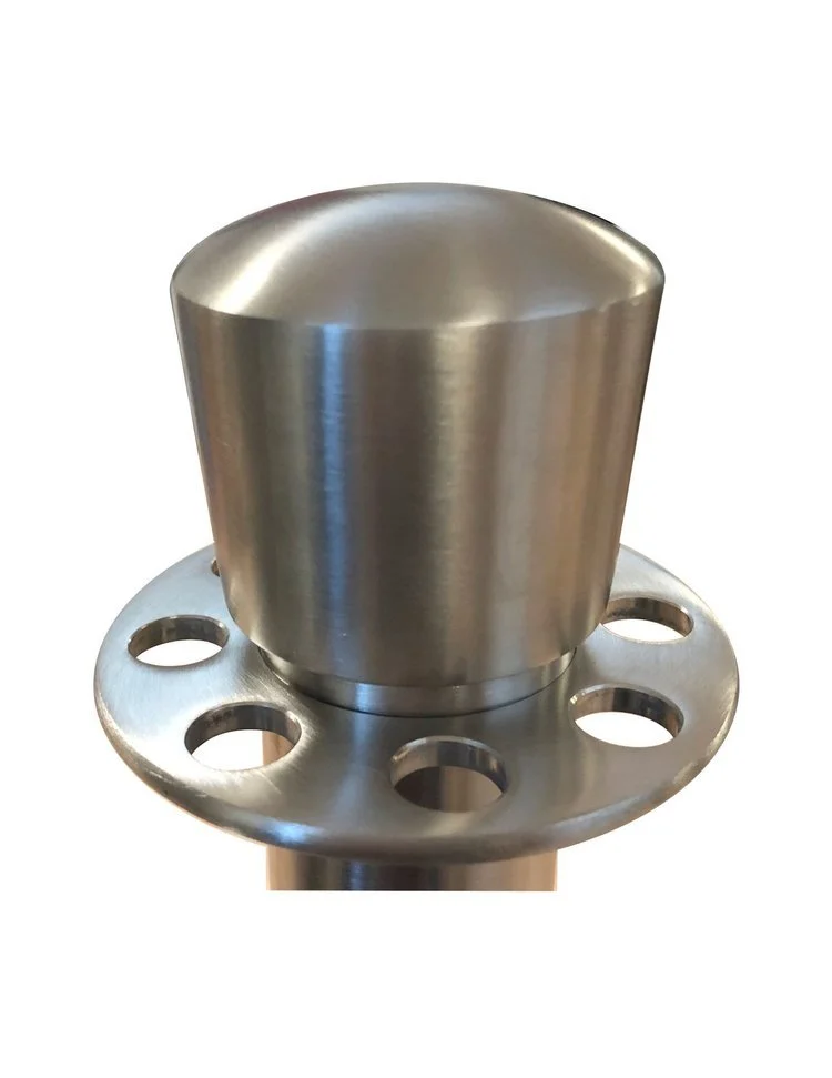 A metallic, cylindrical object with a rounded top attached to a circular base with multiple holes, likely a mechanical or industrial part.