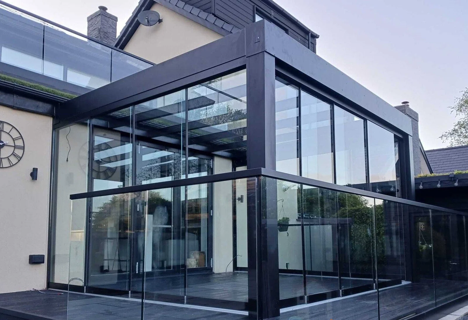 Glass veranda providing a sheltered outdoor seating area.