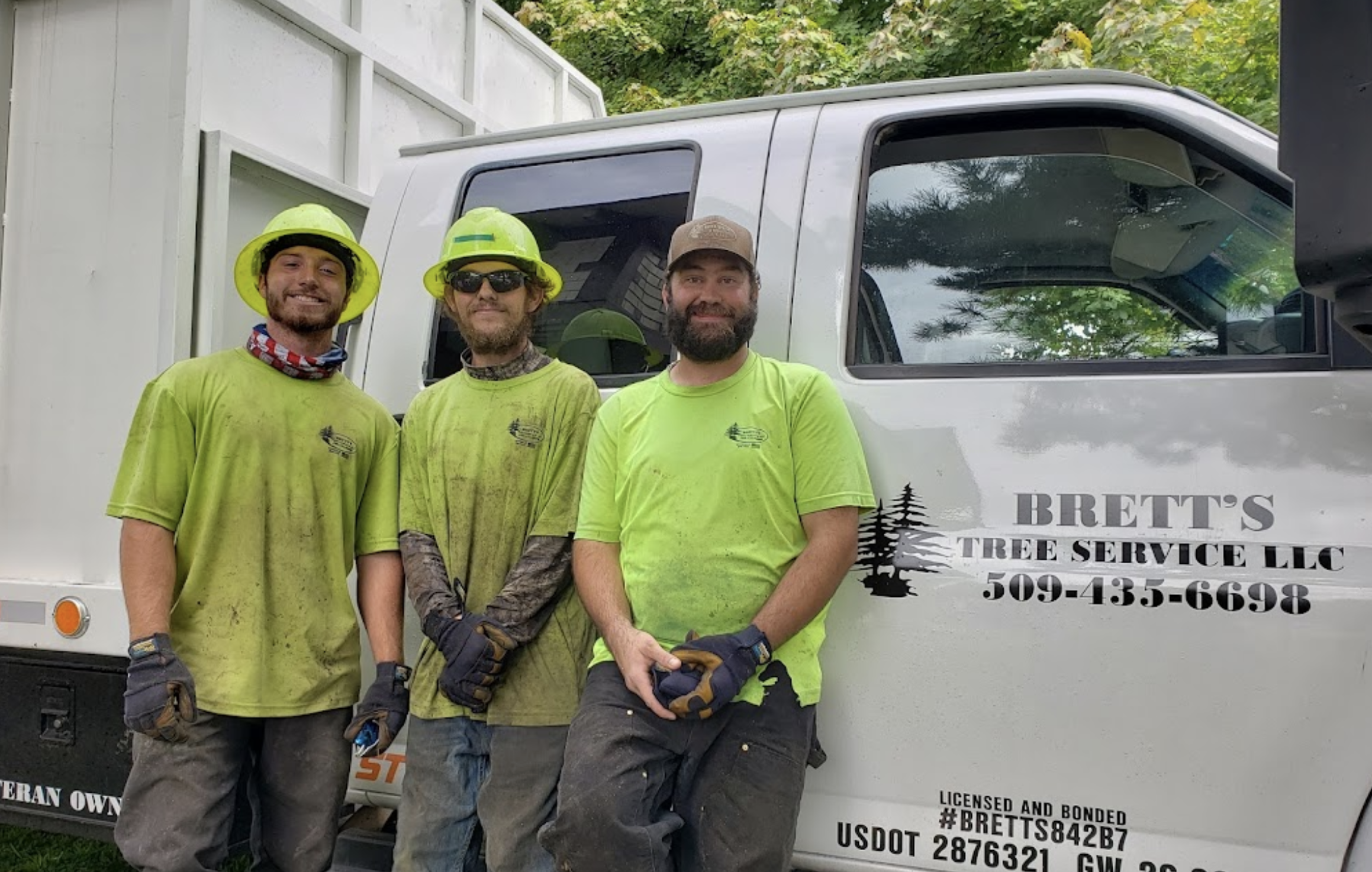 Brett's Tree Service crew in yellow safety shirts in front of work truck- veteran-owned Spokane Valley WA