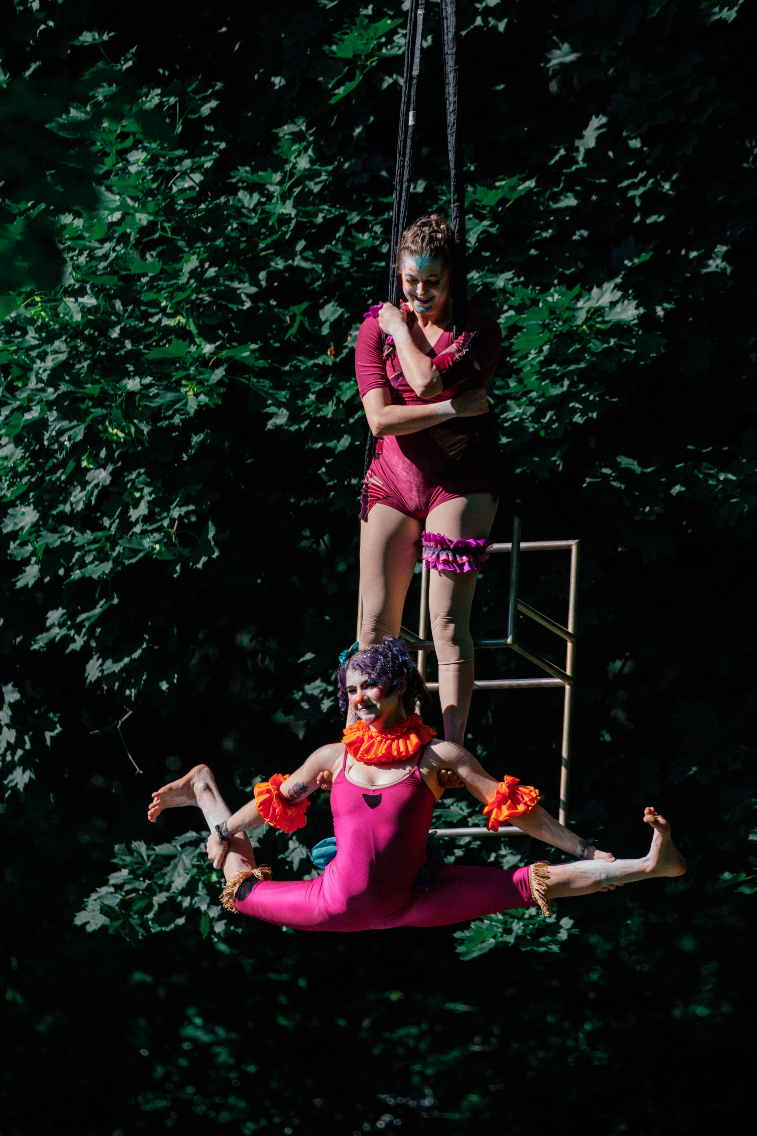 Kenzie basing Cassidy from feet in split.