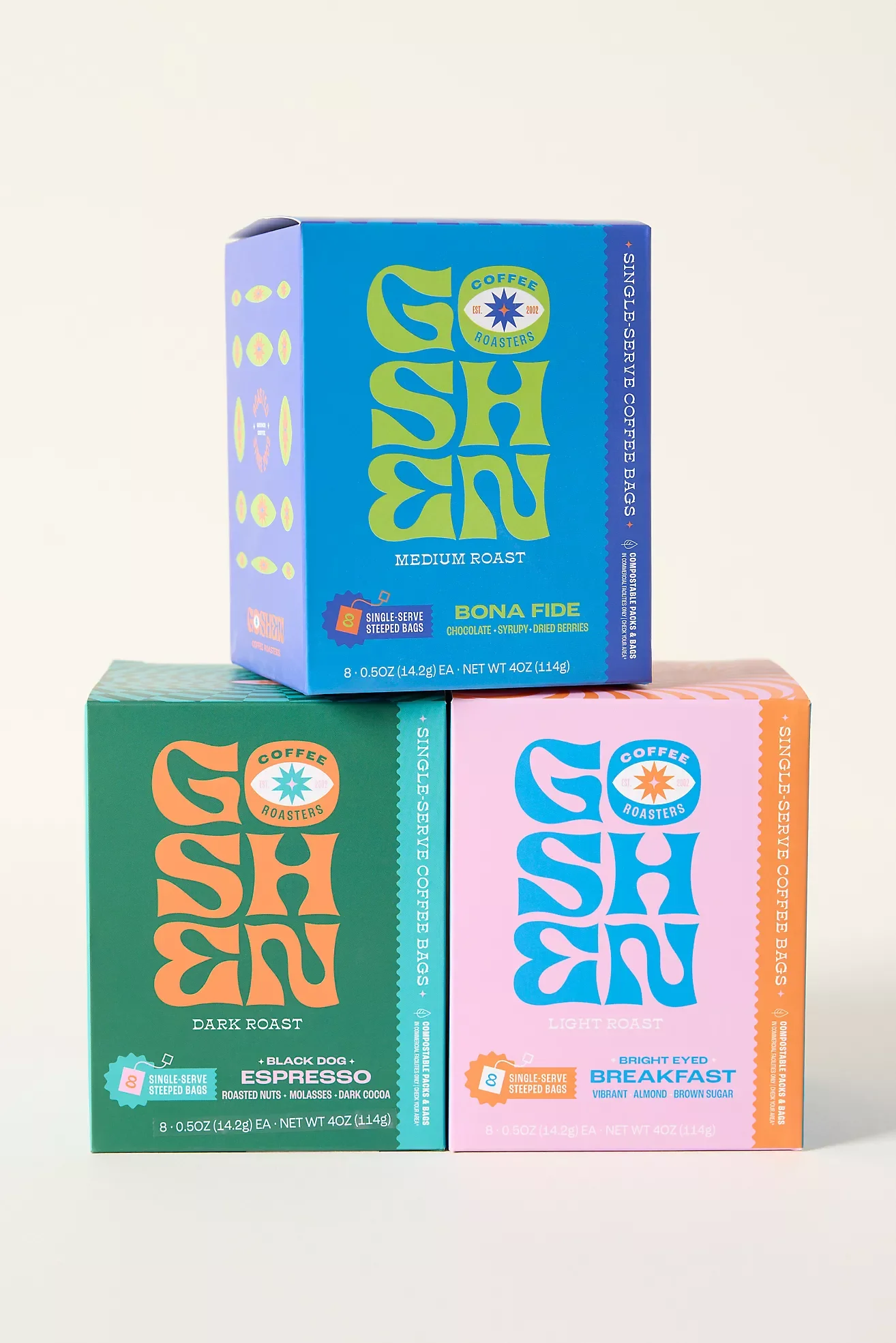 Three boxes of Stumptown Coffee Roasters single-serve coffee bags in different flavors, arranged in an L shape on a white background. The top box is blue with medium roast, the left box is green with dark roast, and the right box is pink with light roast.