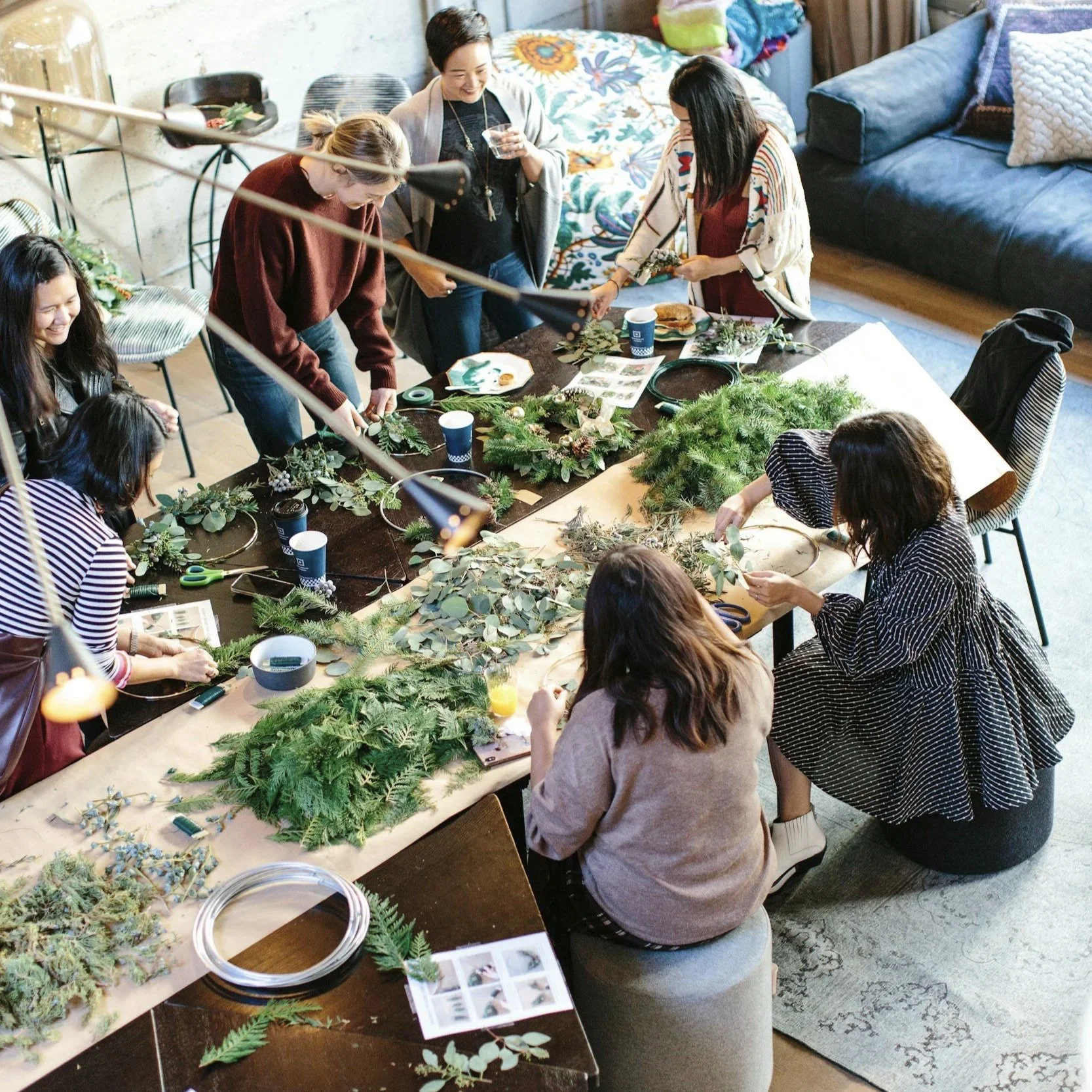 employees gathered around a table doing a plant craft