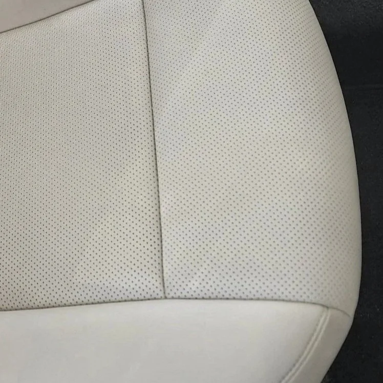 Close-up after leather repair done on this perforated car seat. Burleson Tx