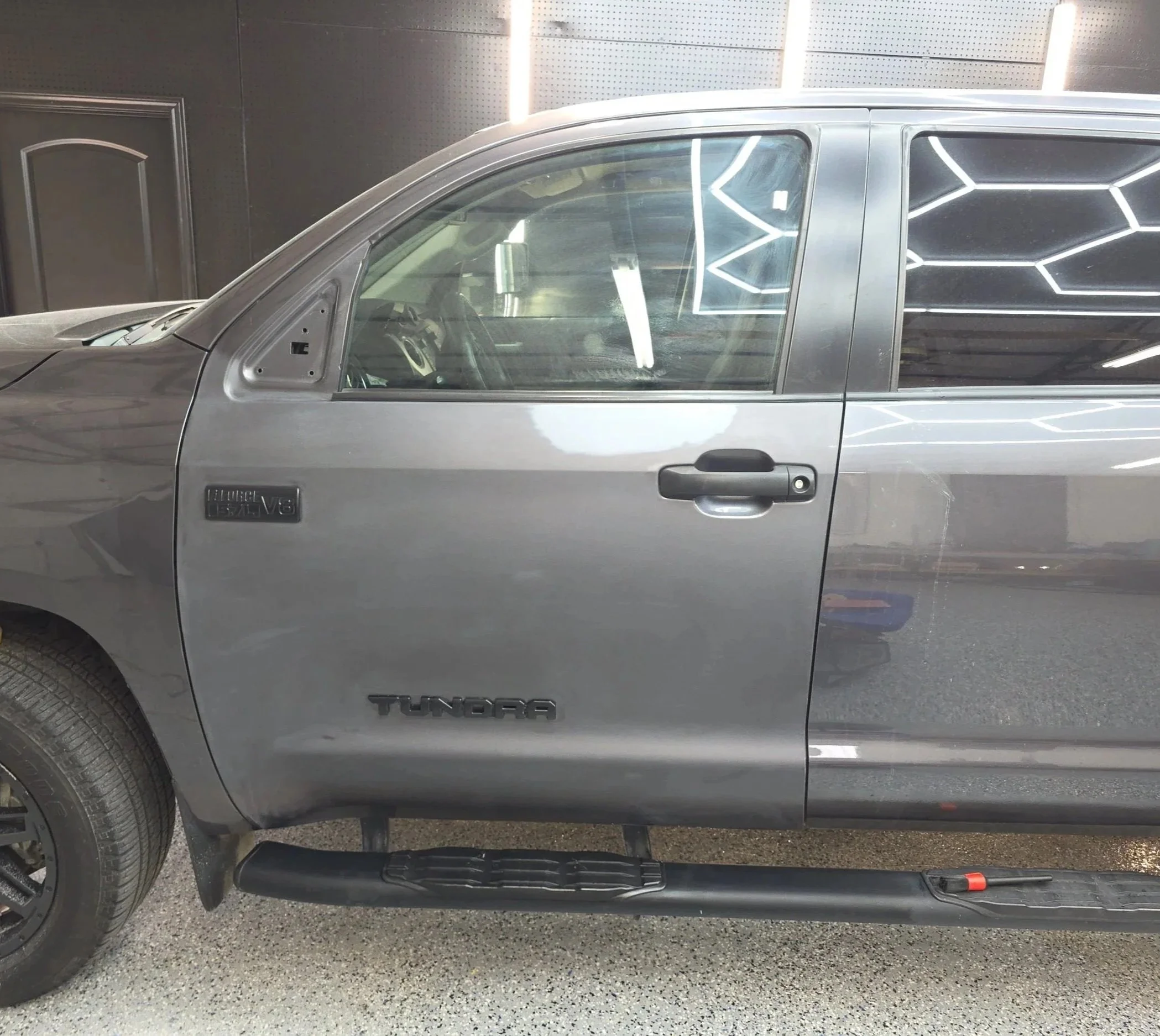 Grey Toyota Tundra getting the driver door painted from damage caused by the side mirror getting hit in Burleson Tx