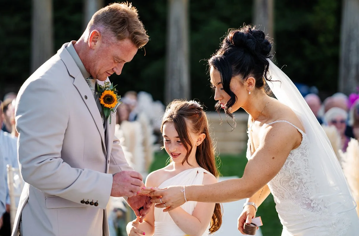 Lakeside outdoor wedding, golden hour and  celebrant led wedding ceremony. Heartfelt vows and rings exchanged and a third surprise ring and family vows. Photography by Georgie Beck