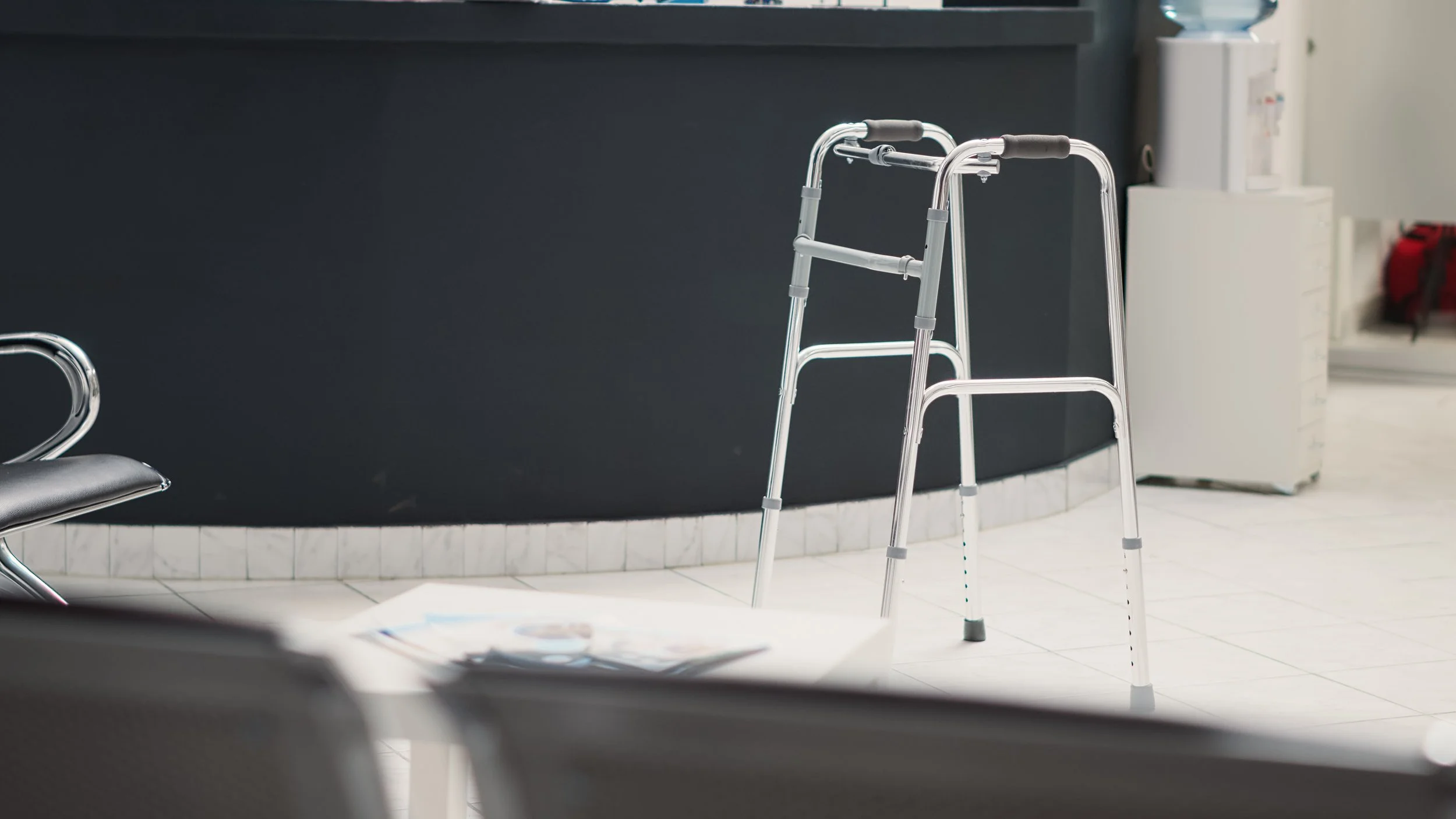 facility-waiting-room-with-walk-frame-lobby-empty-reception-counter-with-checkup-forms-seats-waiting-area-medical-center-with-aid-help-chronic-disability-health-care.jpg