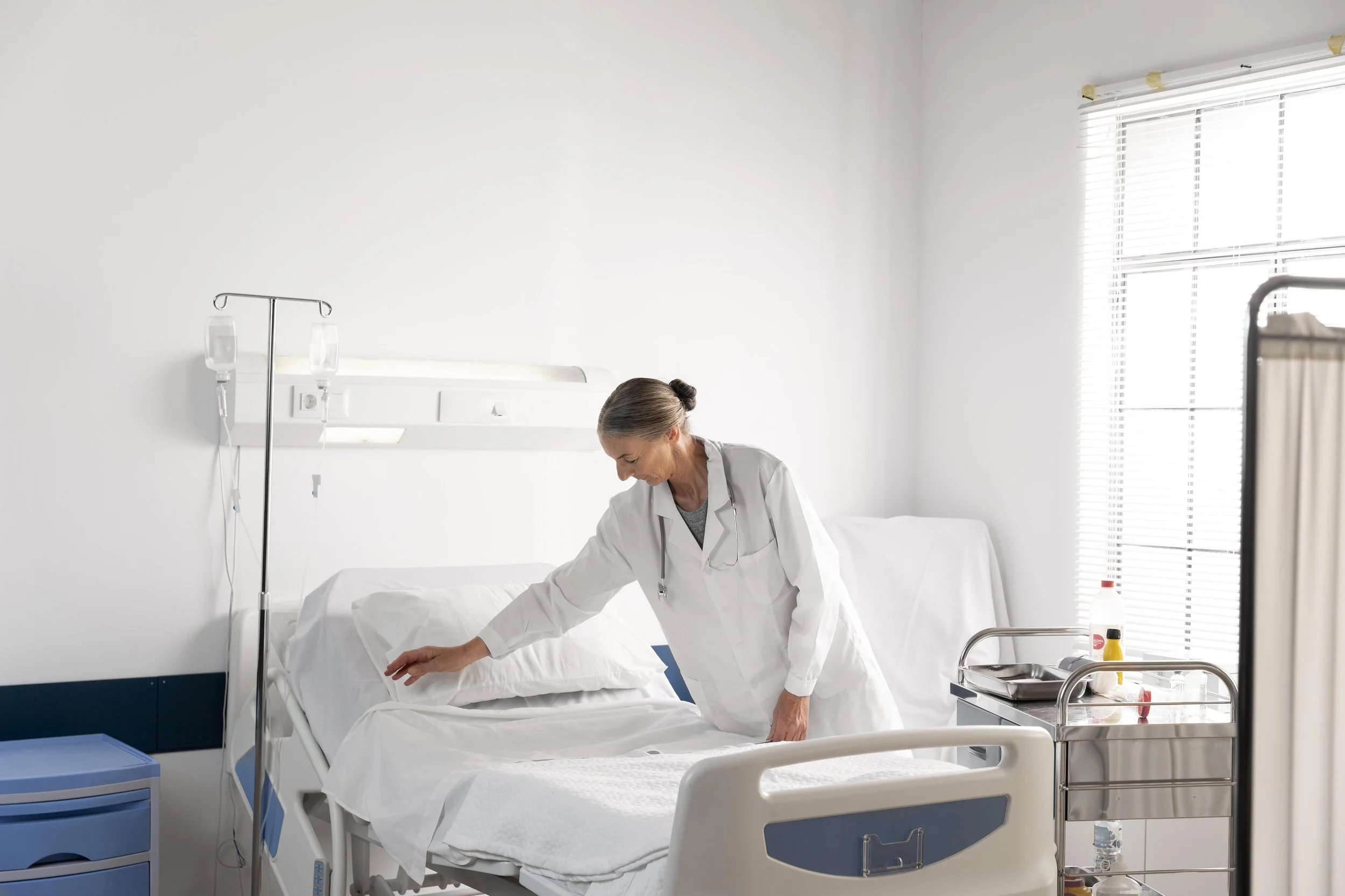 medium-shot-doctor-checking-patient-bed.jpg