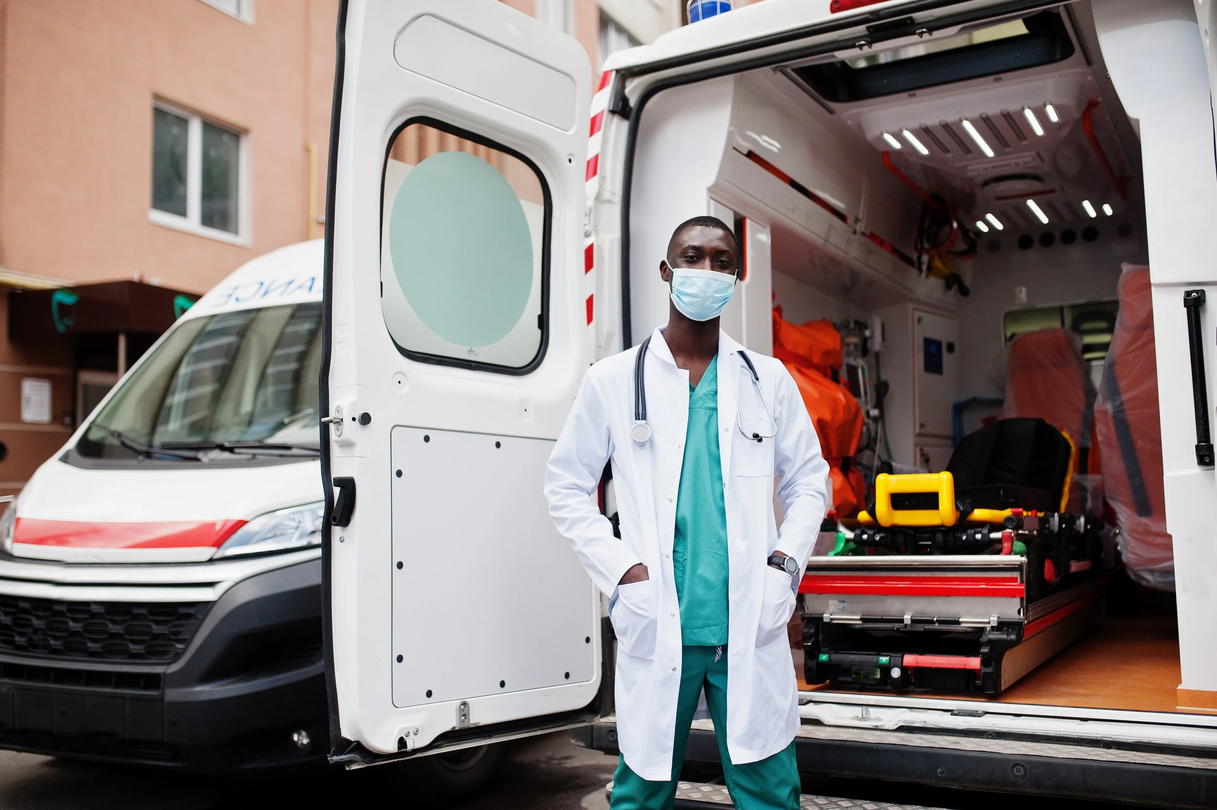 african-male-paramedic-face-protective-medical-mask-standing-front-ambulance-car.jpg