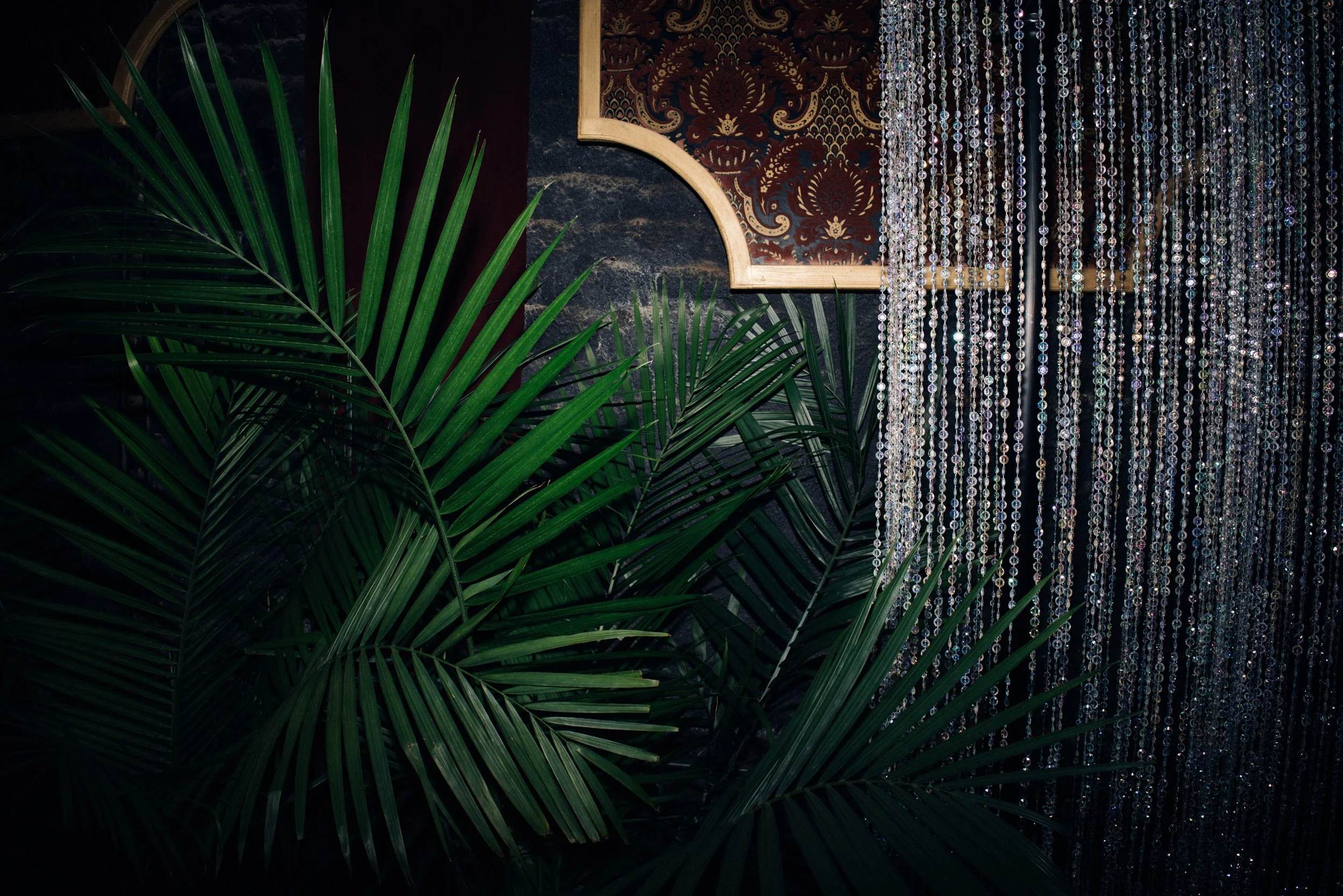 Corporate event lounge styled with tropical plant rentals in New Orleans.