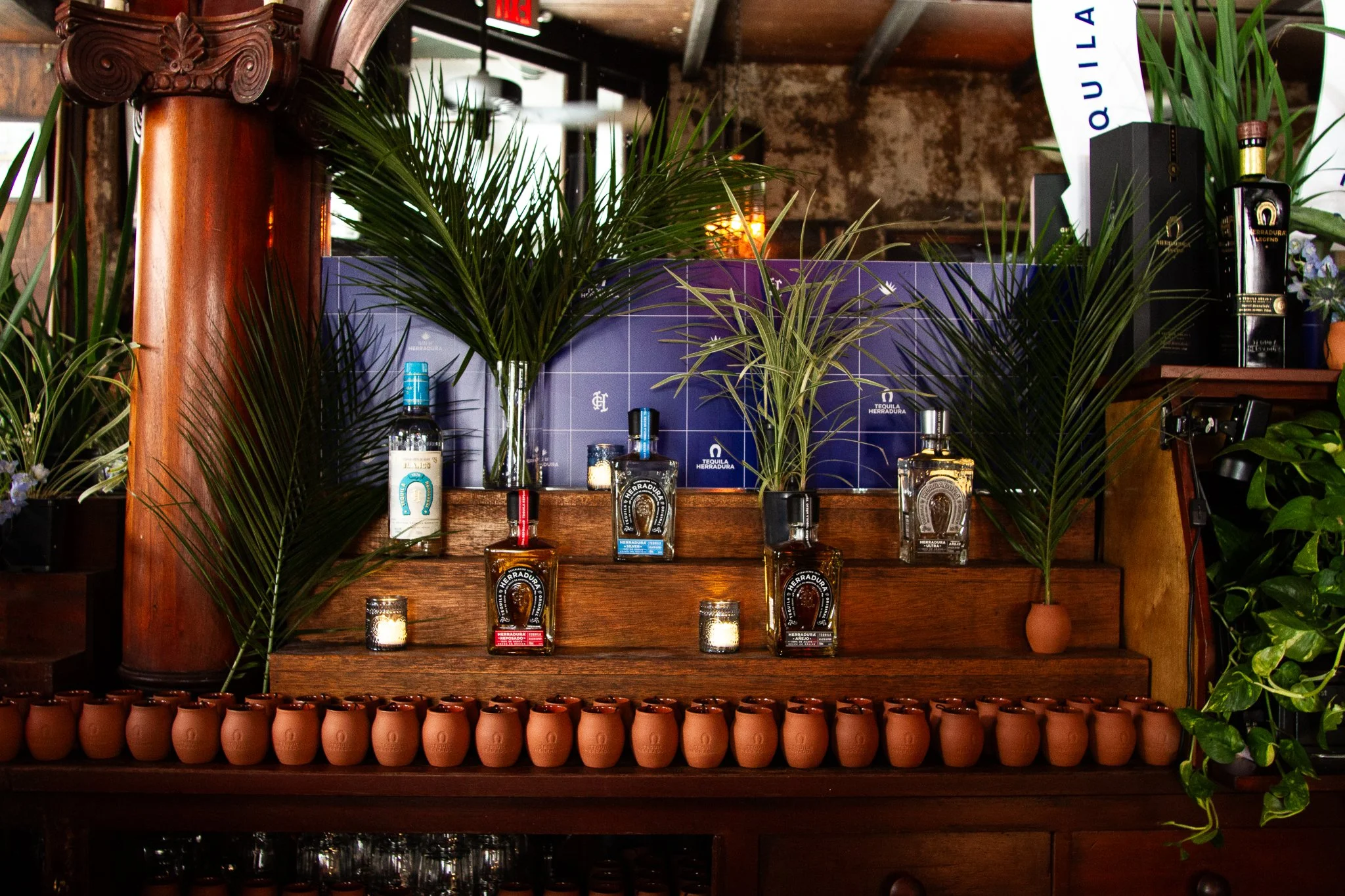 Layered foliage that complements branded bar builds and backdrops.