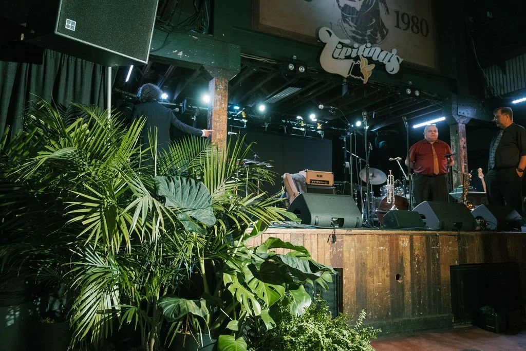 New Orleans event styling inspired by tropical greenery and natural textures.