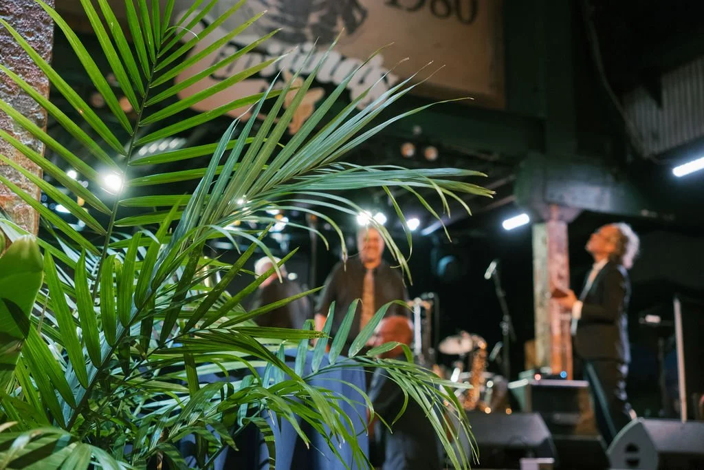 Tropical greenery rentals creating immersive event spaces.