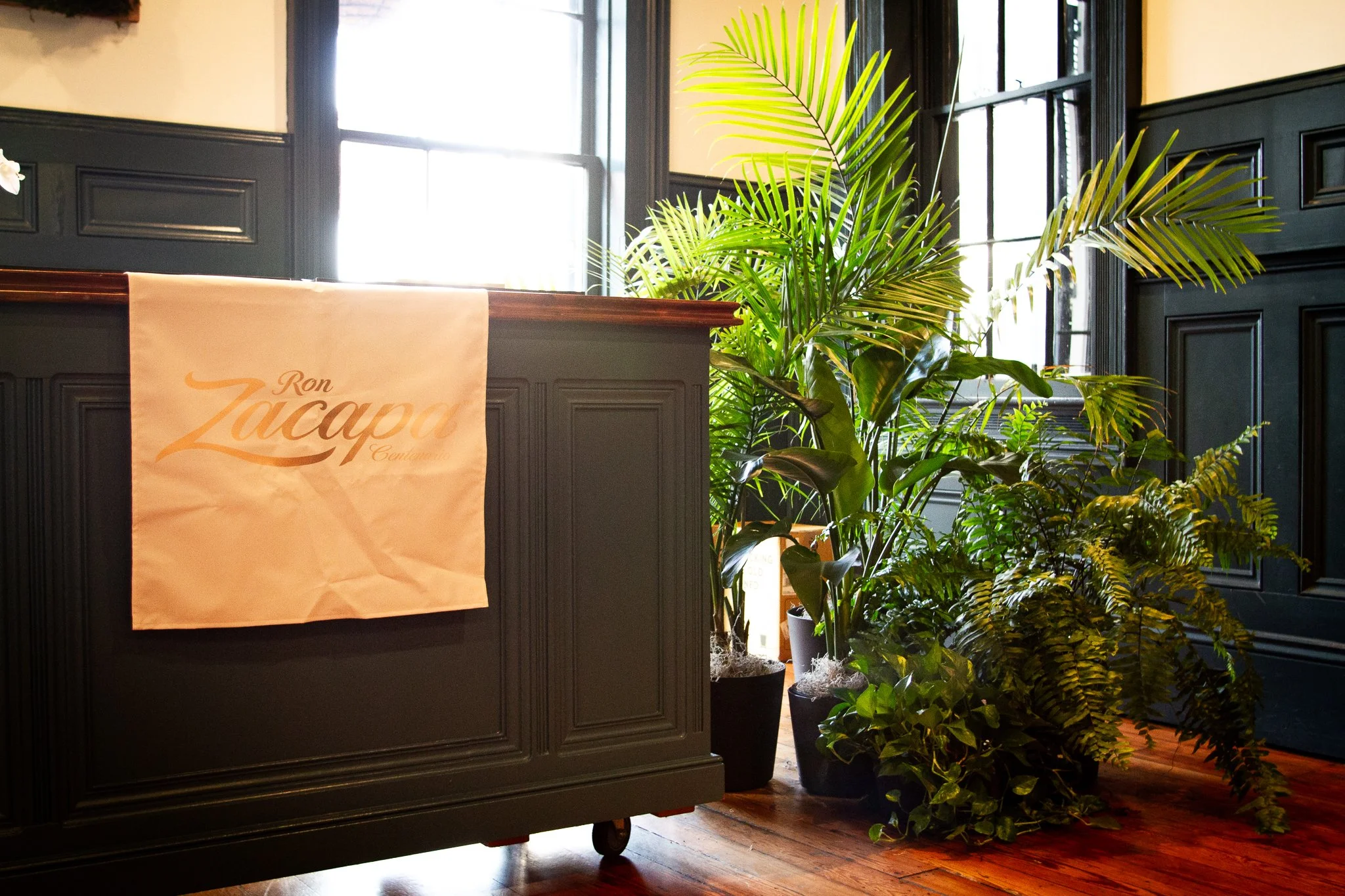 Fresh greenery rentals designed and styled to frame sampling stations and bars.