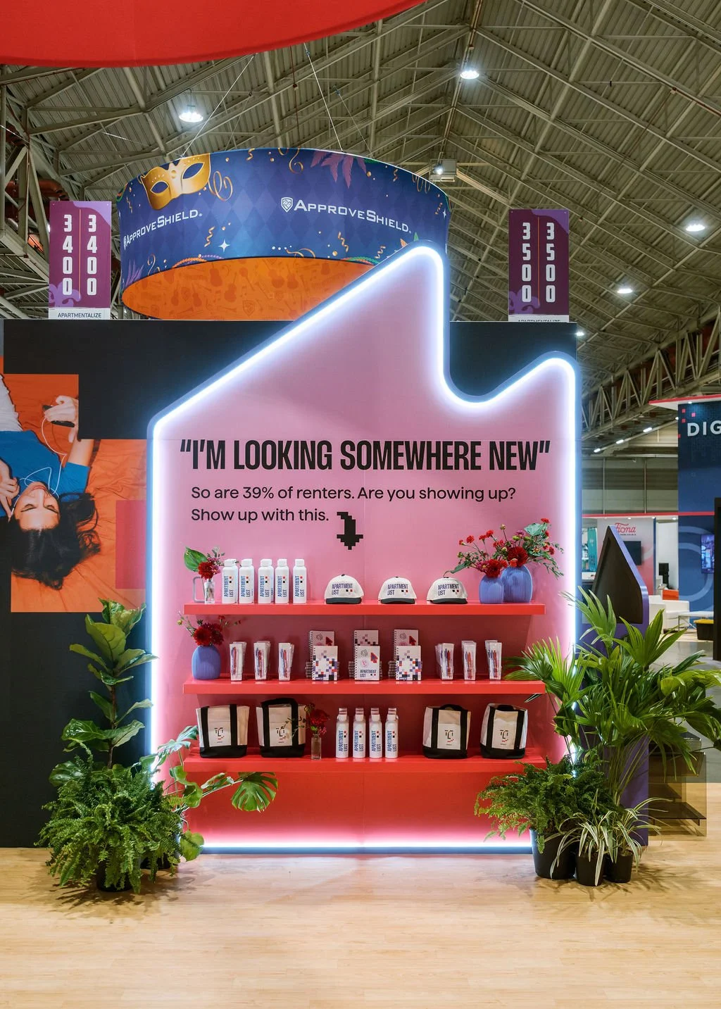 Product display framed with tropical greenery rentals in New Orleans.