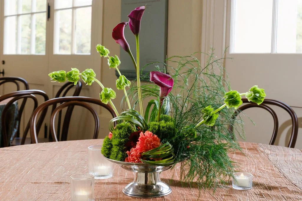 Greenery forward centerpiece with seasonal florals New Orleans plant rentals and Floral