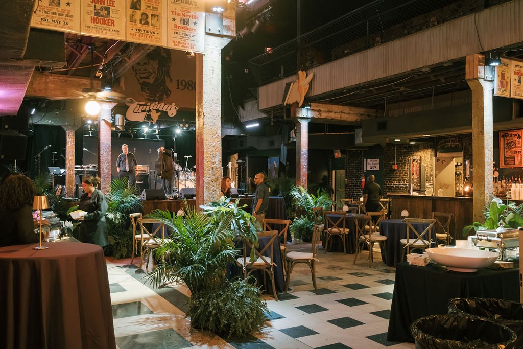 New Orleans event dance floor featuring lush tropical plants.