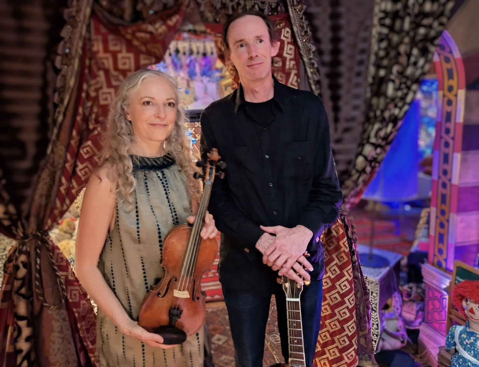 Suzuki Cady holding fiddle with a couple dancing