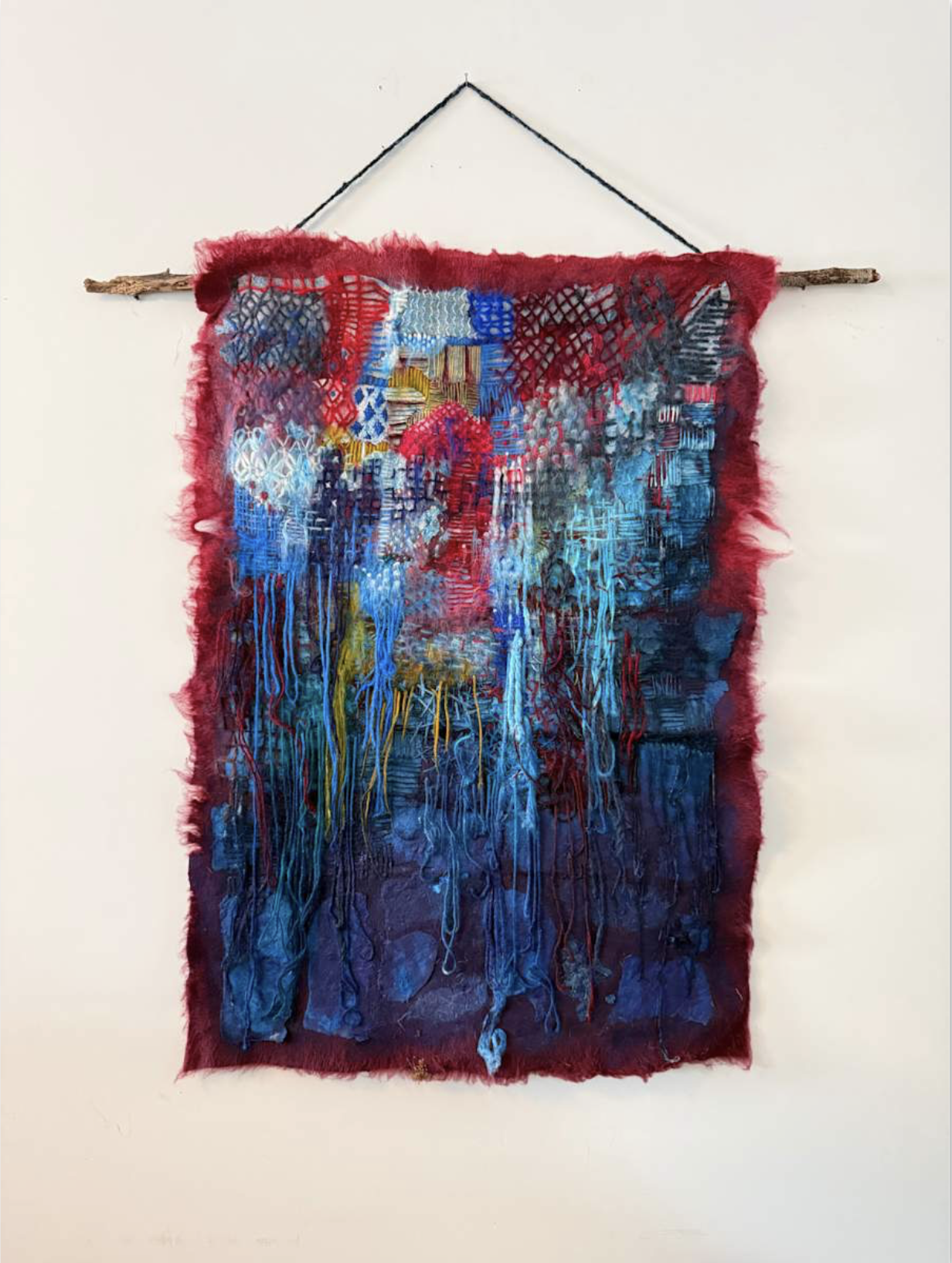 My Rewilding: Returning to the Ground, 2026, 20" by 26", dryer lint, felt, yarns, acrylic paint, wood