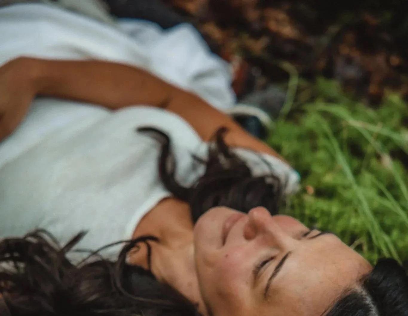 somatic therapy Lara Wehbe laying on grass