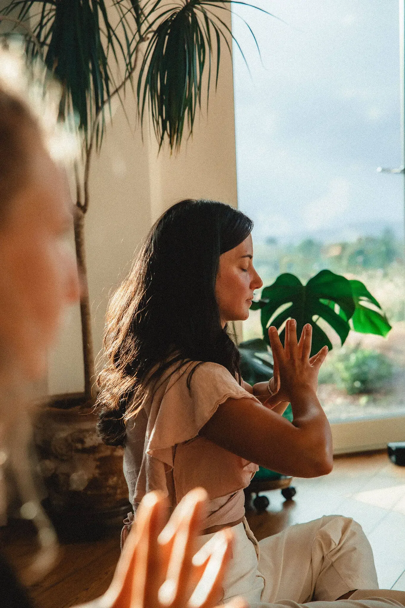 Lara Wehbe Somatic Therapy in Meditation with Mudra in her hands