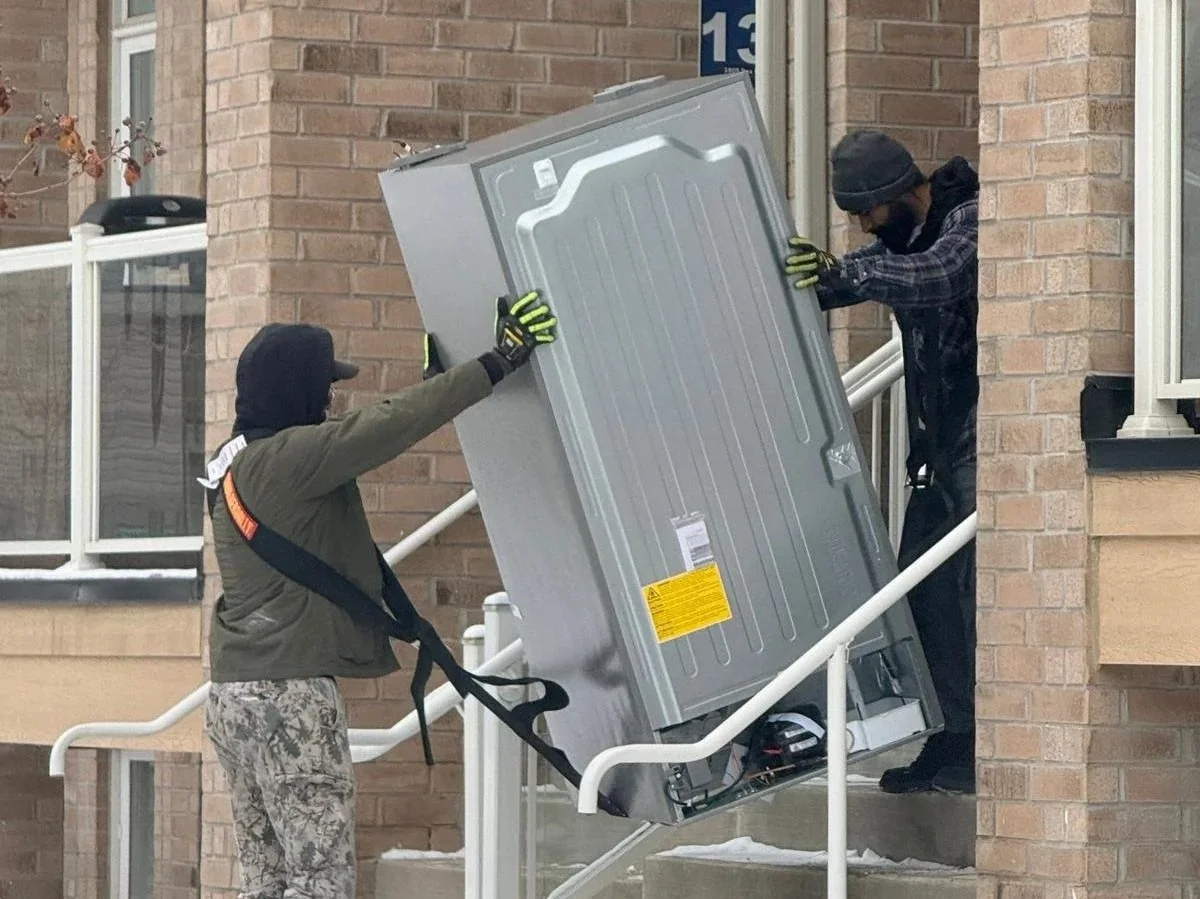 MyCourier delivery associates delivering a big and bulky item to a home