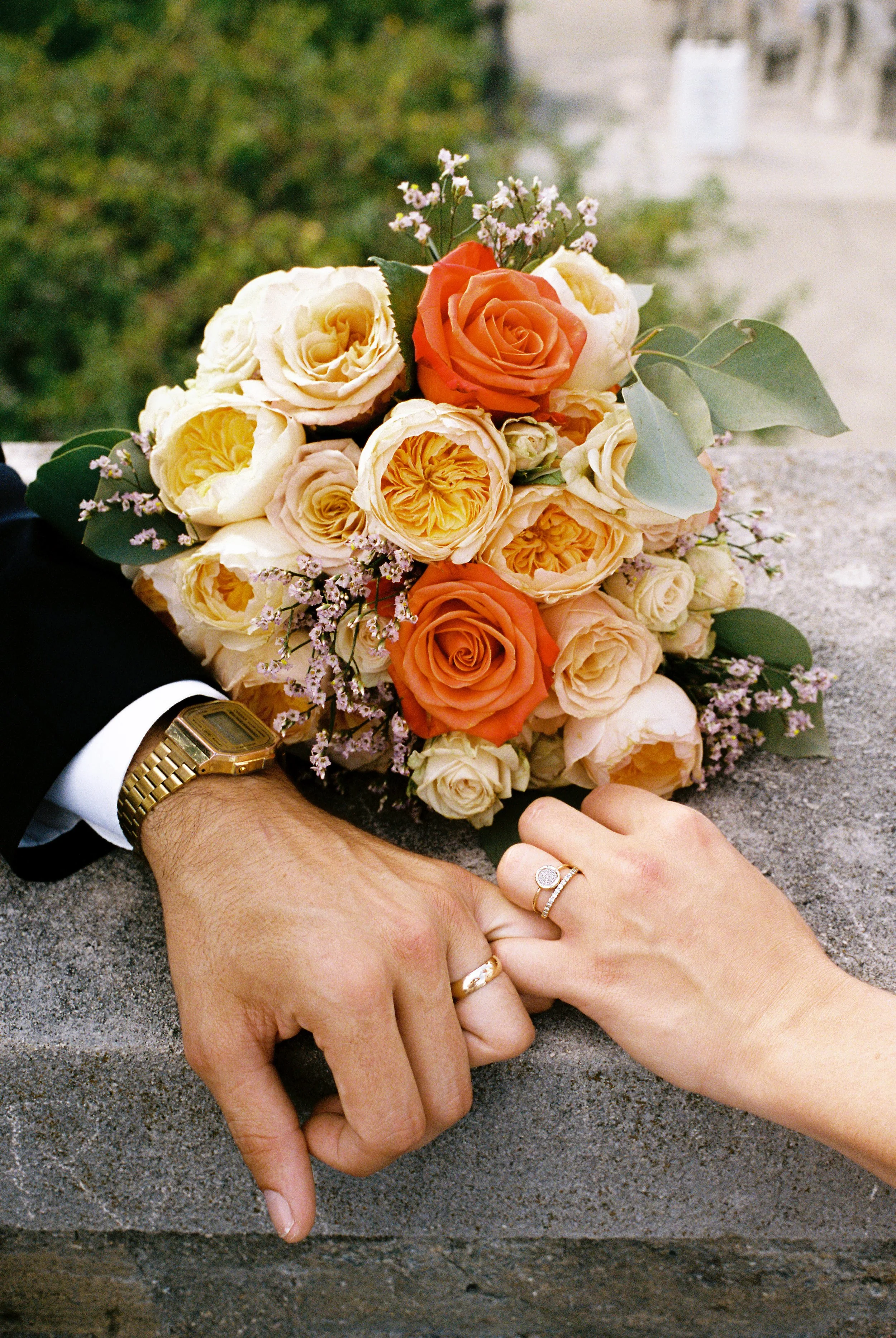 Newlyweds lock pinkies in a photo showing their wedding rings and bouquet. Cincinnati, Ohio, wedding on film.