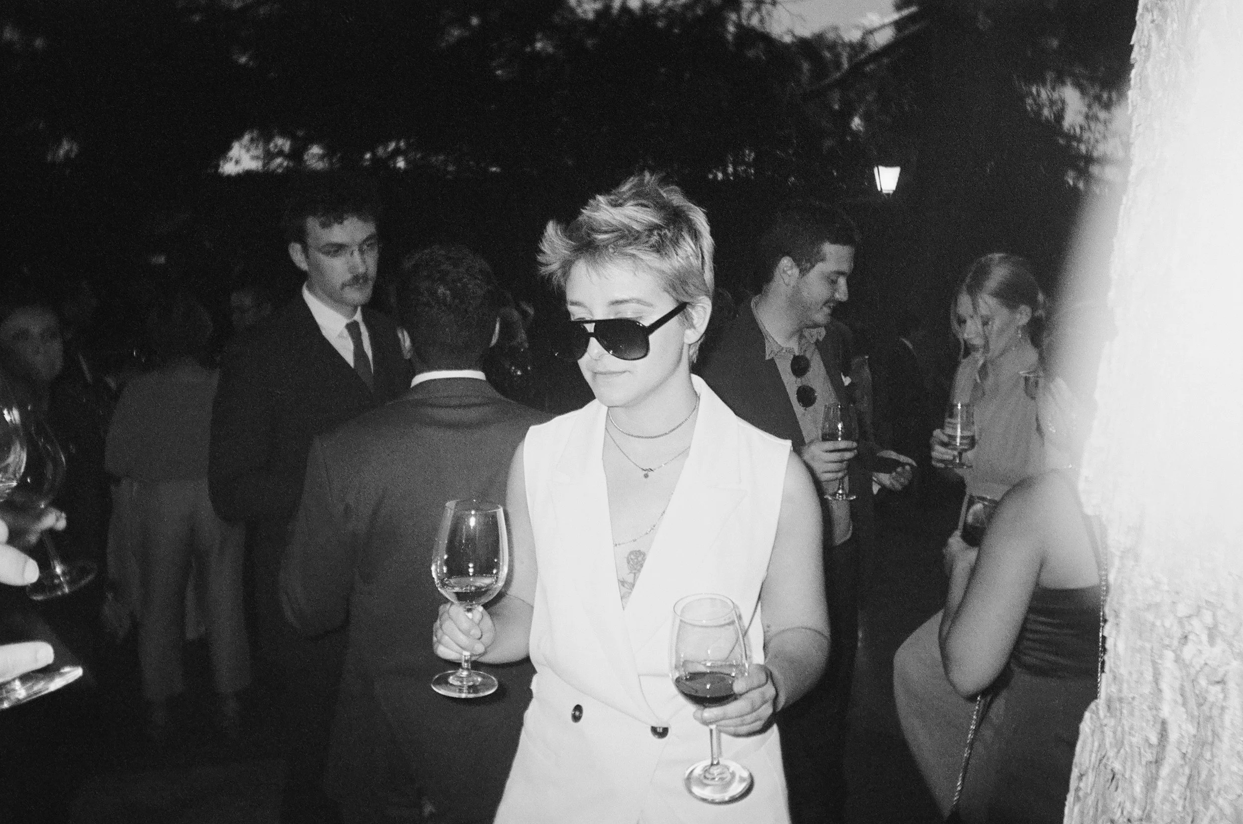Guest poses for a portrait at a summer wedding in Madrid, Spain. Photographed on film.