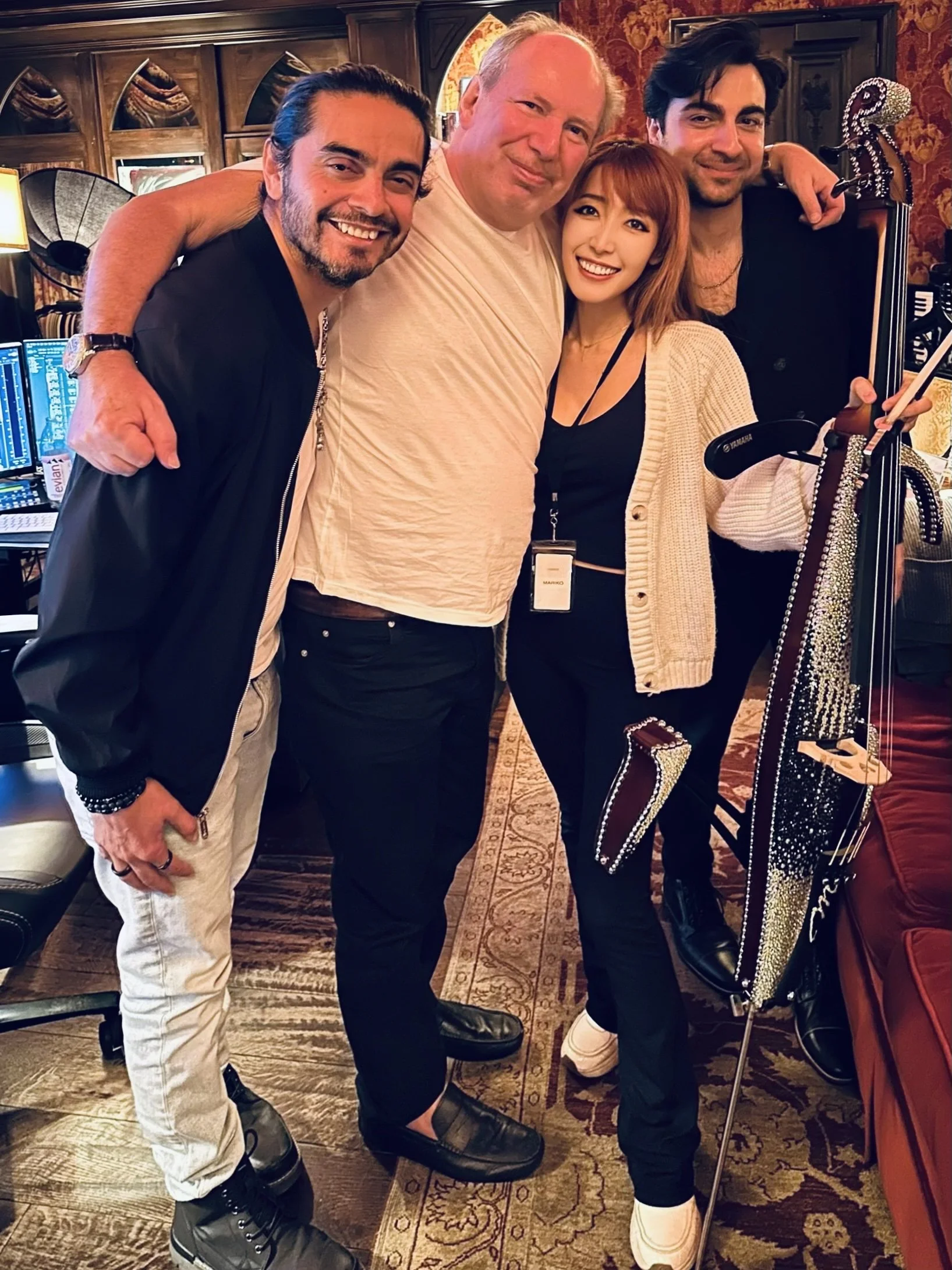 Raul Vega in picture with film composer legend Hans Zimmer, smiling at the camera with his colleague Taurees Habib and cellist Mariko Muranaka. They are in Hans Zimmer's room after a session has wrapped.