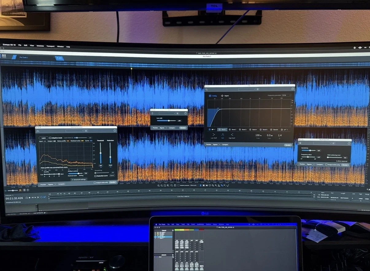 A computer screen displaying an audio editing software with waveform and equalizer settings, with a smaller laptop below showing a digital audio workstation interface. The background has a wall and part of a monitor mounted above.