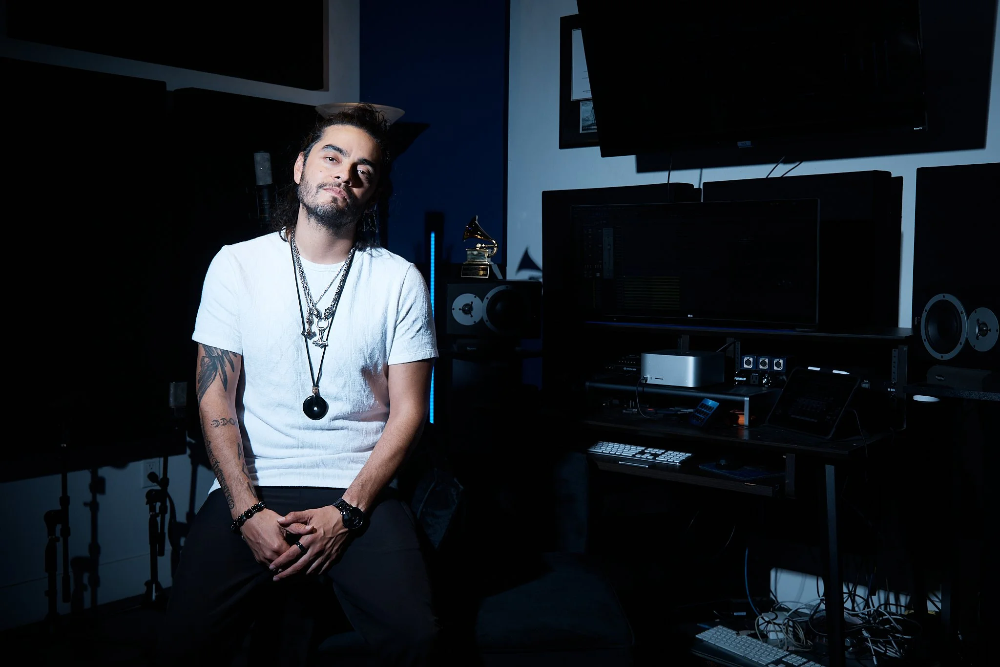 Grammy winning recording engineer Raul Vega sitting in Phantom Voixes Voice Over studio in Los Angeles, surrounded by studio gear and equipment.