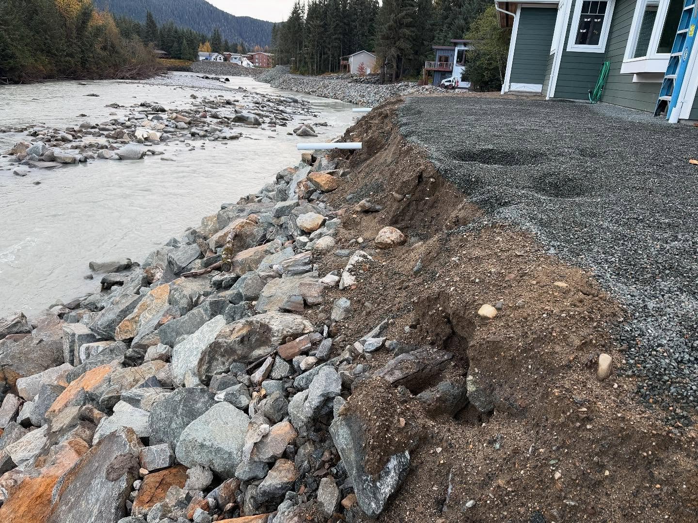 This client has been rebuilding her home since the flood of 2023. Last year, we did some light landscaping to give her a bit of usable space while she worked to recover. Then came the 2024 flood, which carved out the edge of her yard and started eati