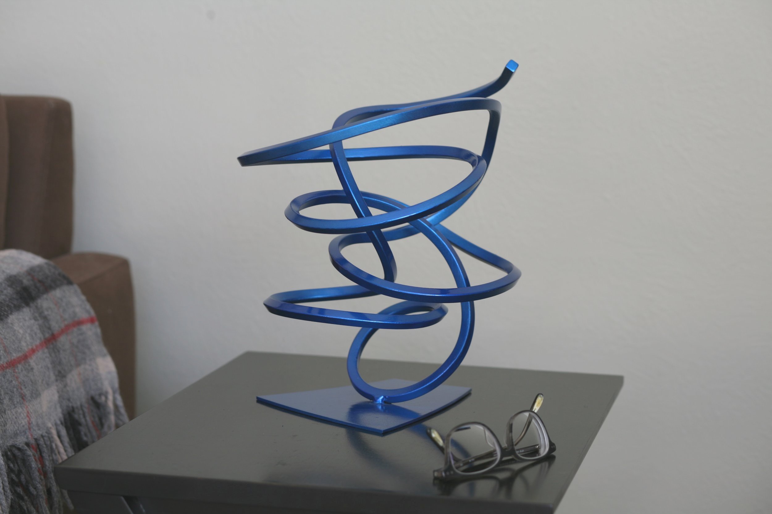 Twisted steel abstract sculpture, blue metallic