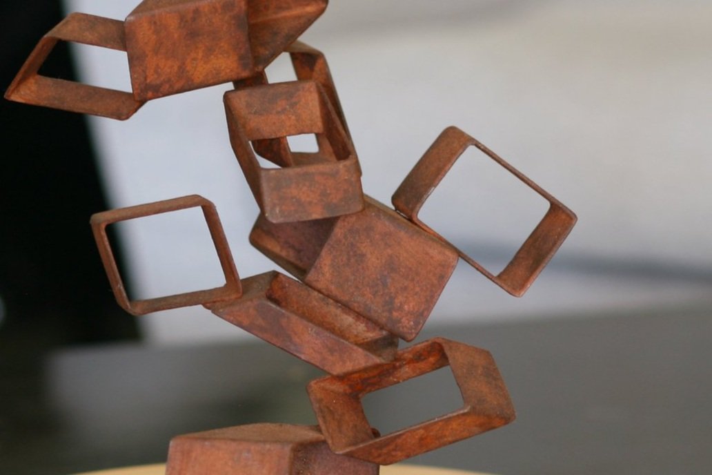 Detail of Rusted steel abstract sculpture with sectioned tubing